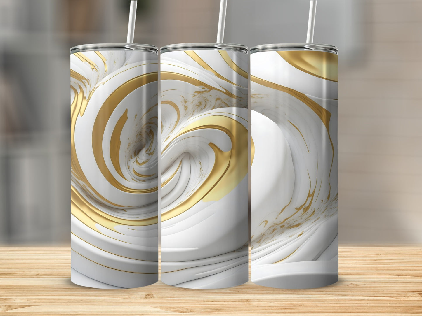 Three white and gold marbled tumblers with straws on a wooden surface.