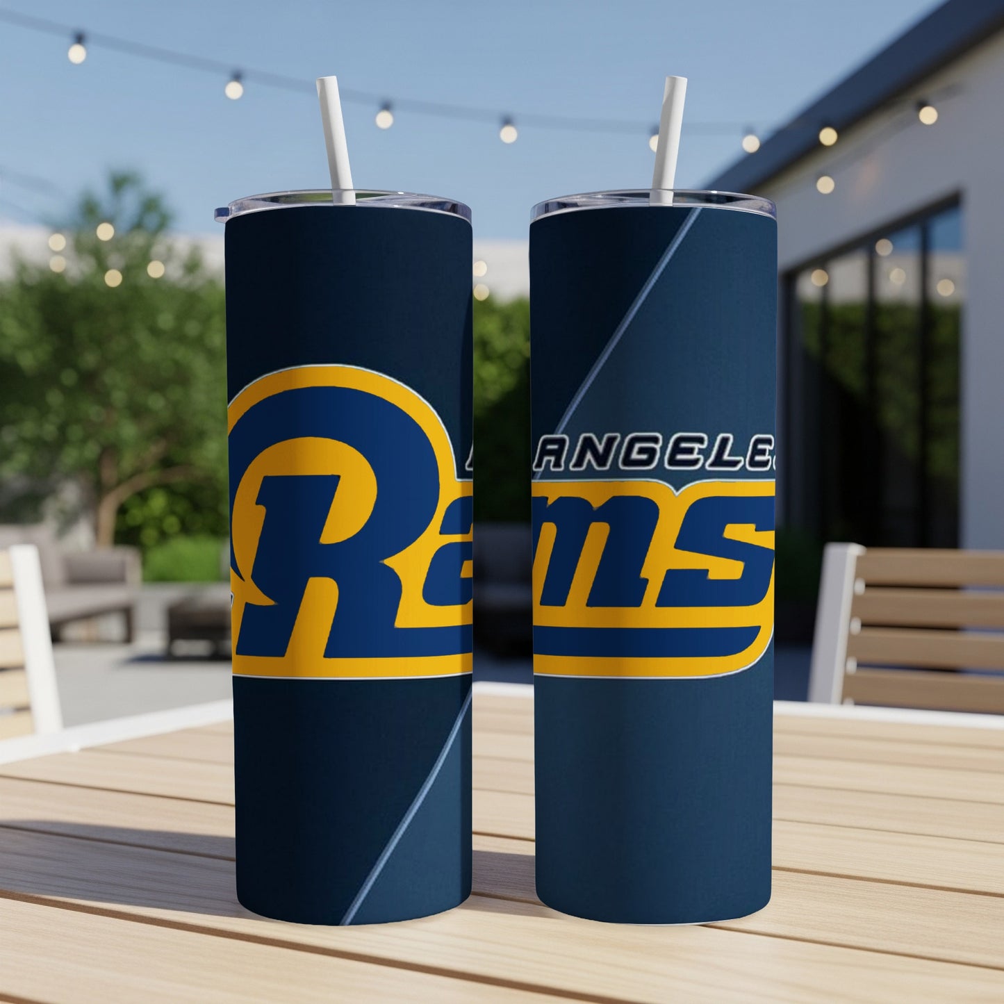 Two Los Angeles Rams tumblers with white straws on a wooden table.