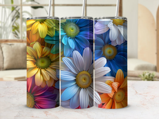 Three tumblers featuring colorful floral designs on a white and marble surface.