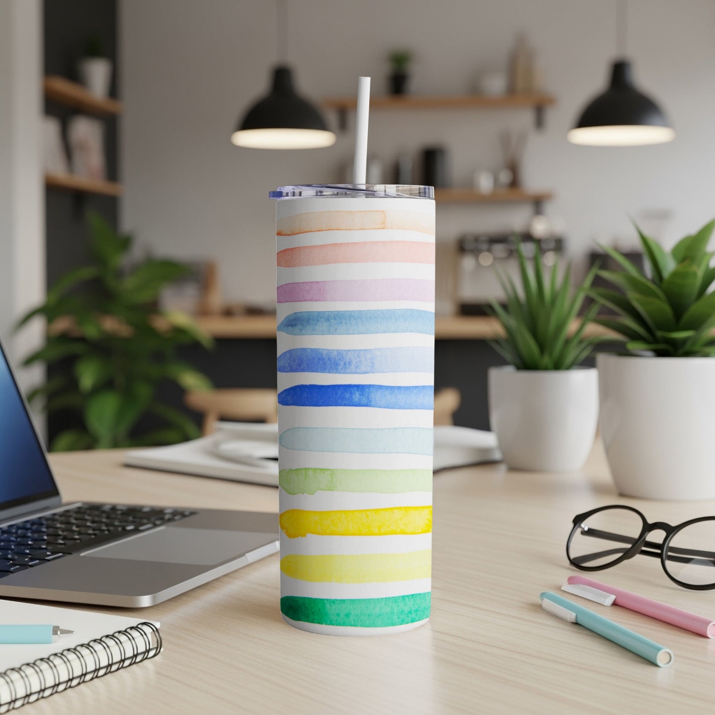 White tumbler with horizontal watercolor stripes of various colors.