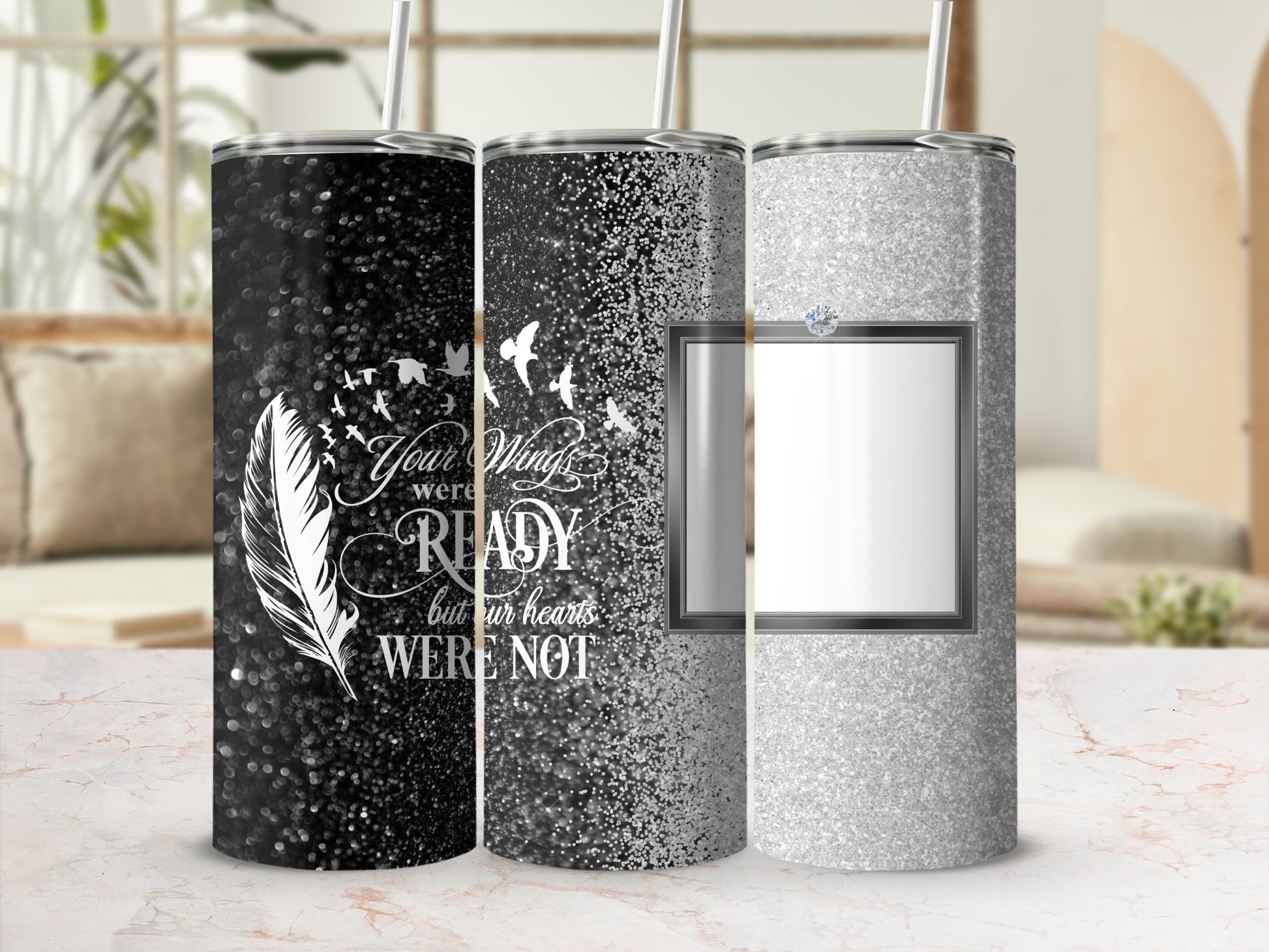 Three glitter tumblers with feather and bird designs.
