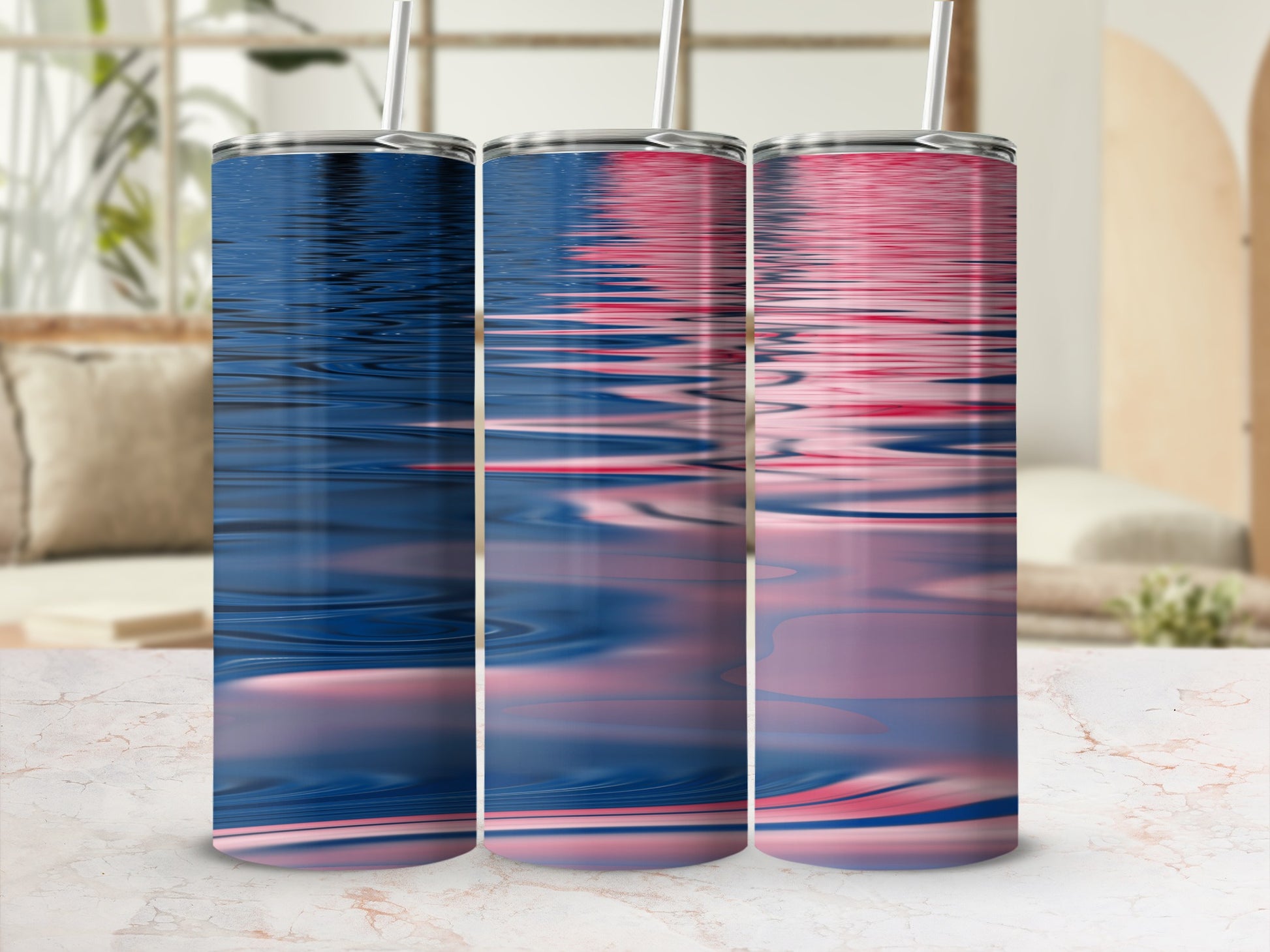 Three tumblers with rippling water design on a marble surface.