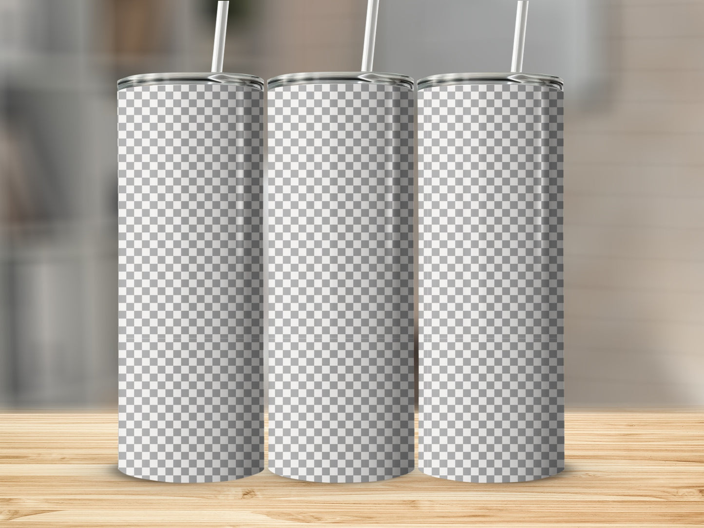 Three blank checkered tumblers with straws on a wooden surface.