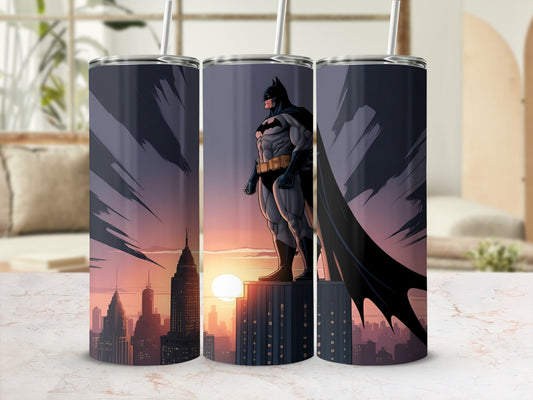 Batman standing on a rooftop overlooking a city at sunset.