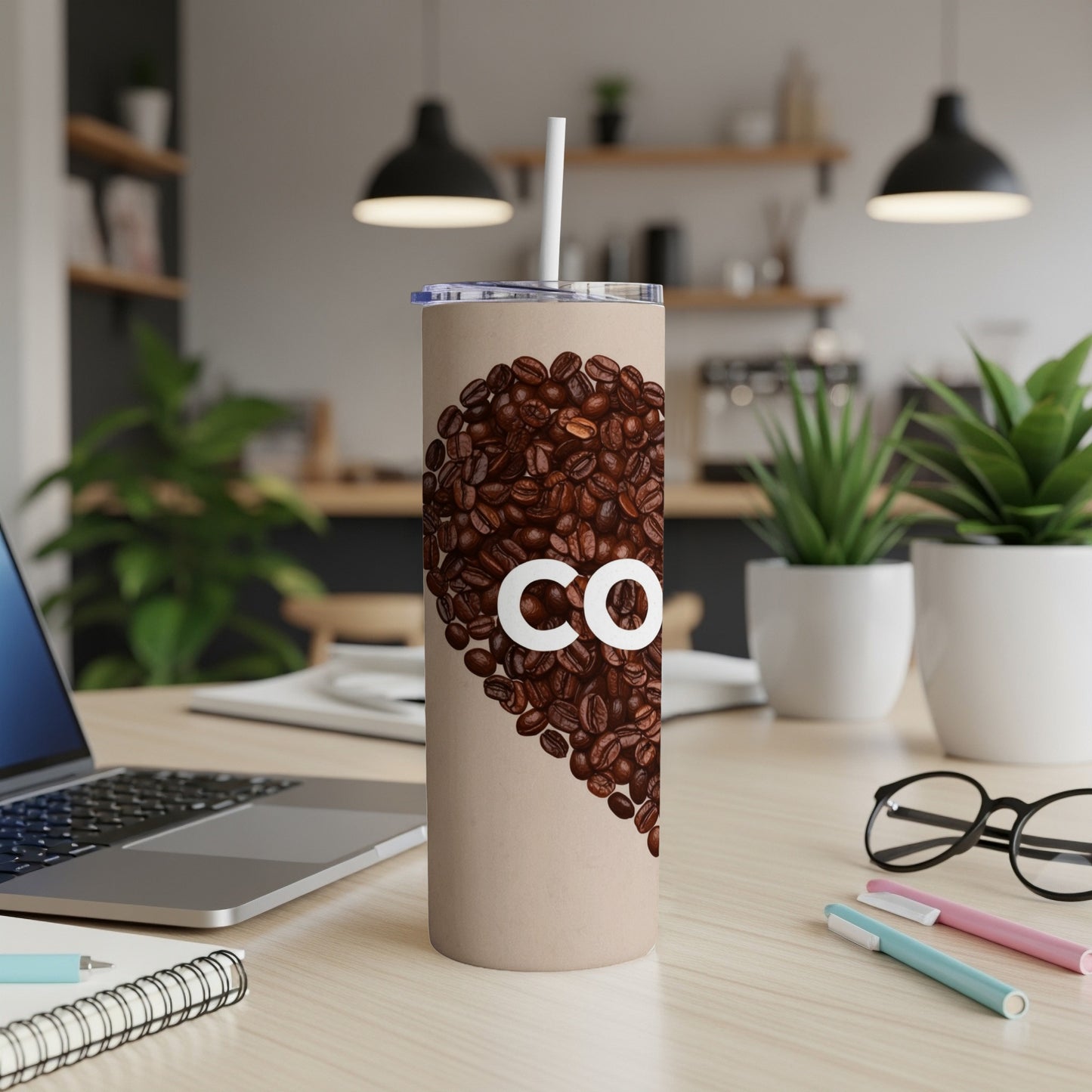Beige tumbler with coffee beans forming a heart shape and "CO" text.