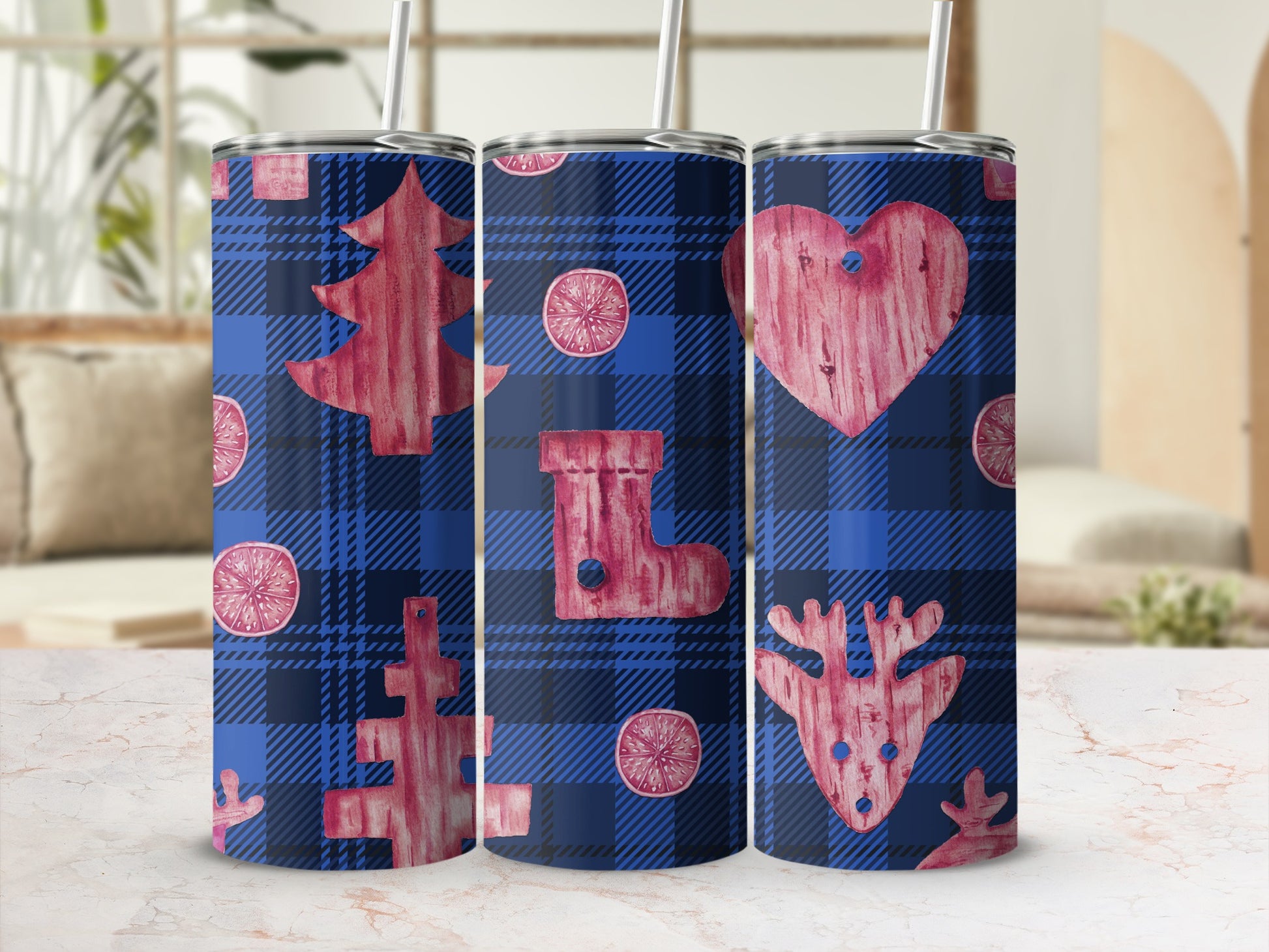 Blue plaid tumbler with Christmas tree, stocking, and reindeer designs.