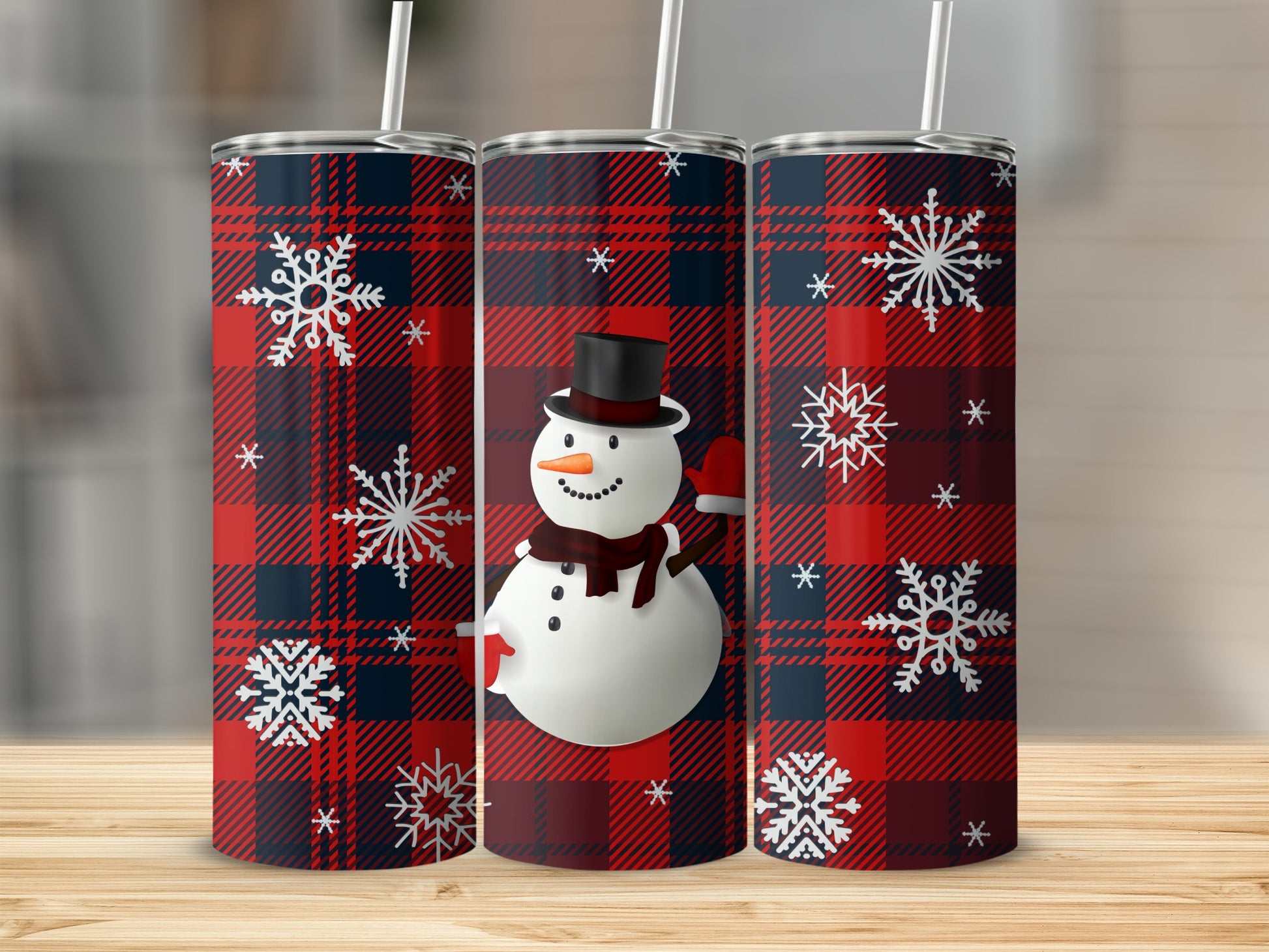 Three tumblers with red and black plaid pattern and snowflakes.