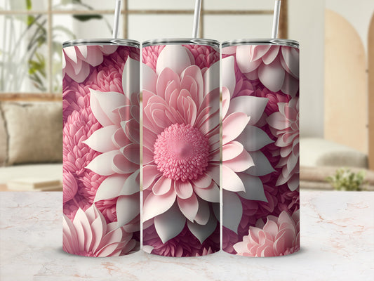 Three pink floral patterned tumblers with straws against a blurred background.