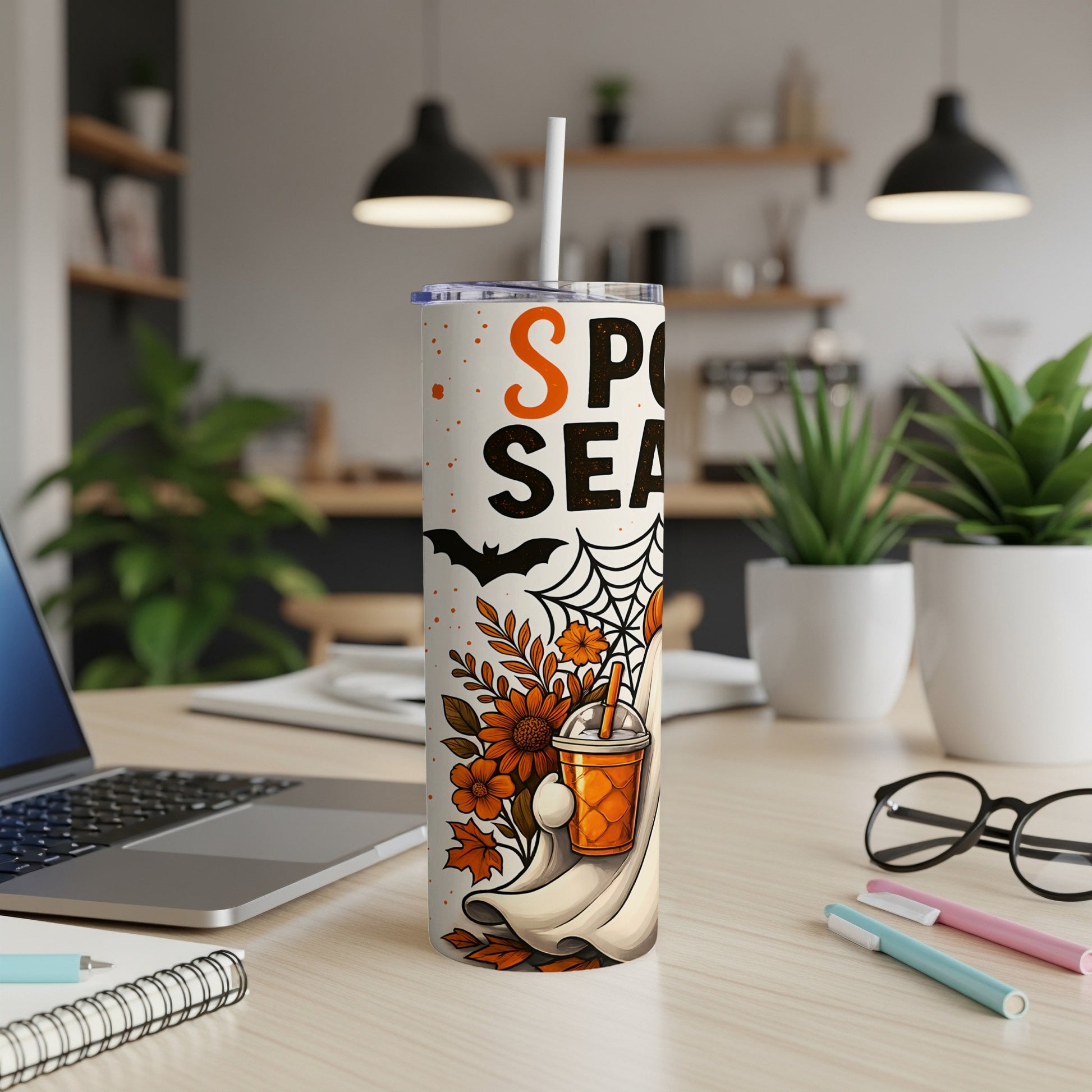 Tumbler with "Spooky Season" text, ghost, and fall leaves design.