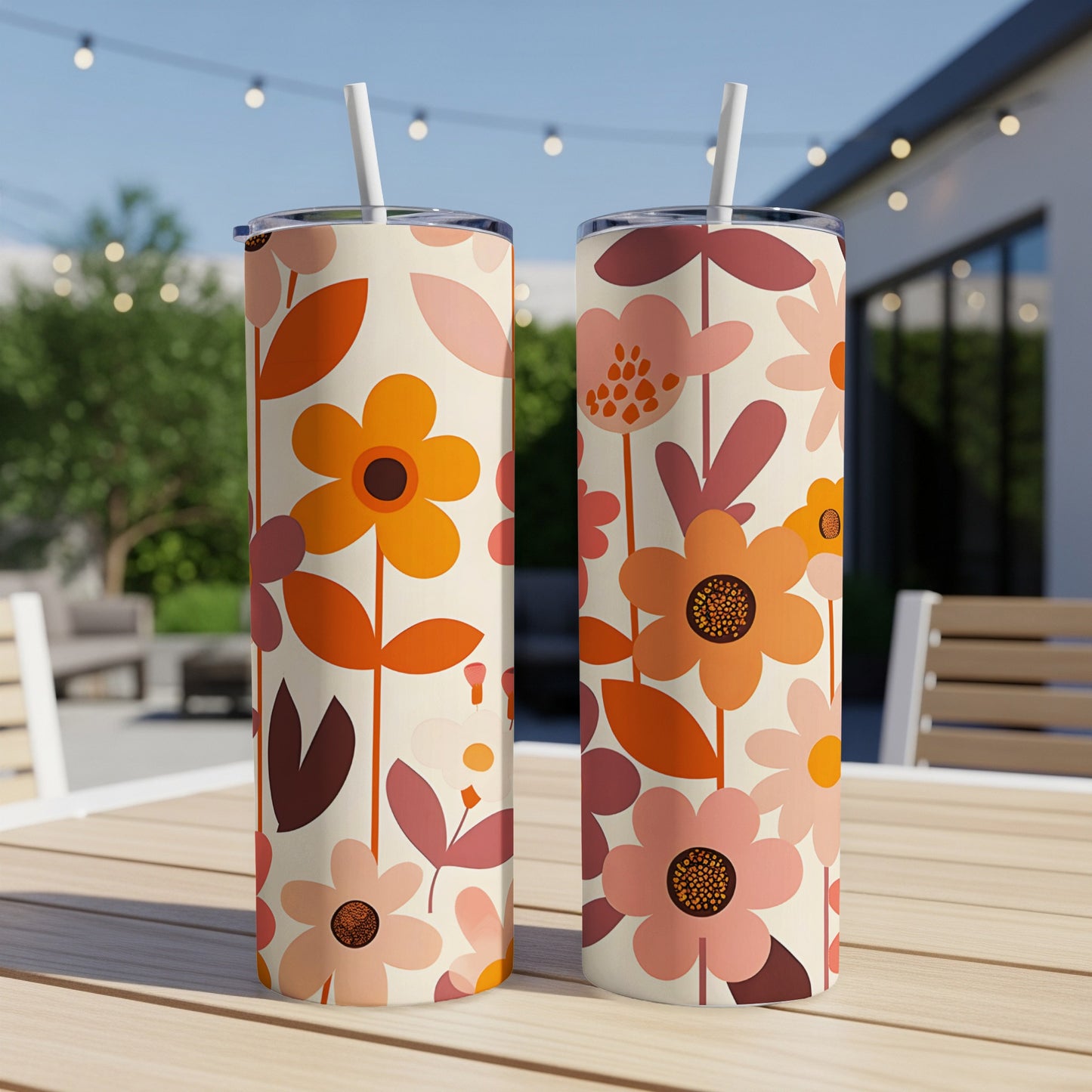 Two tall tumblers with a retro floral pattern sit on a wooden table.