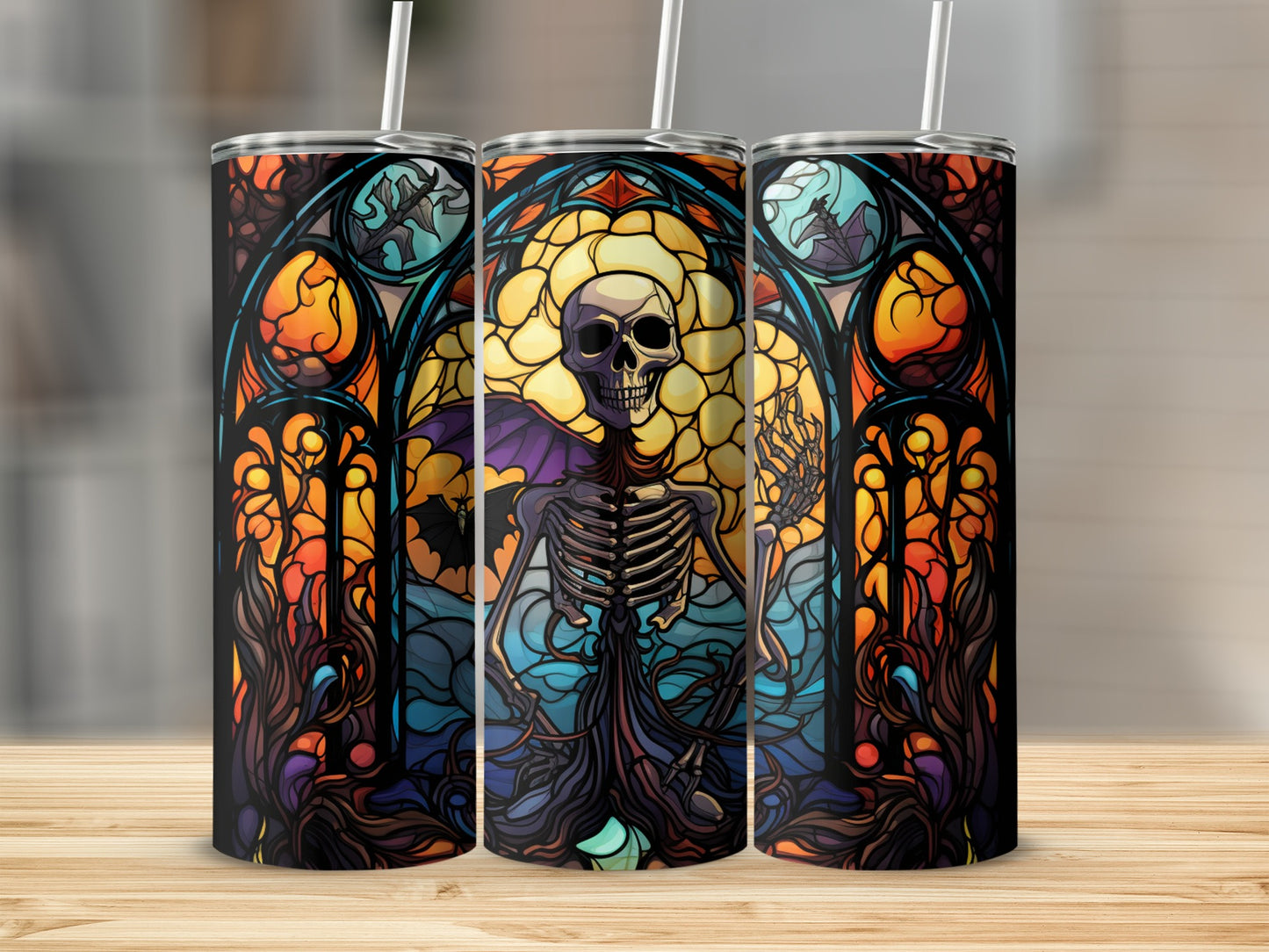 Skeleton in stained glass window design on three tumblers.