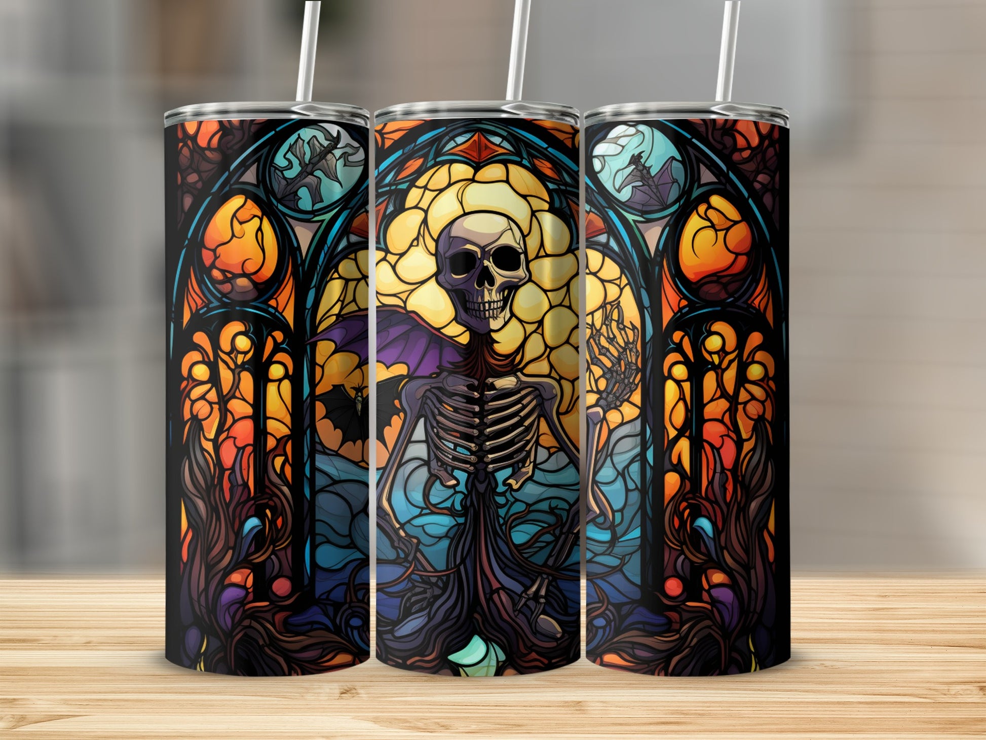 Skeleton in stained glass window design on three tumblers.