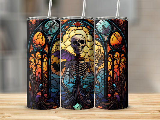 Skeleton in stained glass window design on three tumblers.