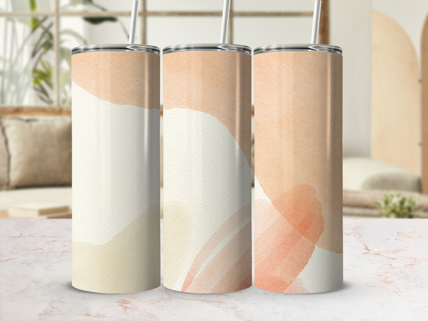 Three tall, thin tumblers with abstract watercolor patterns in beige and peach hues.