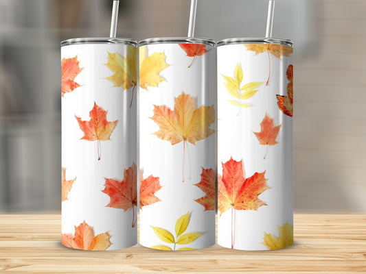 White tumbler with fall leaves pattern.