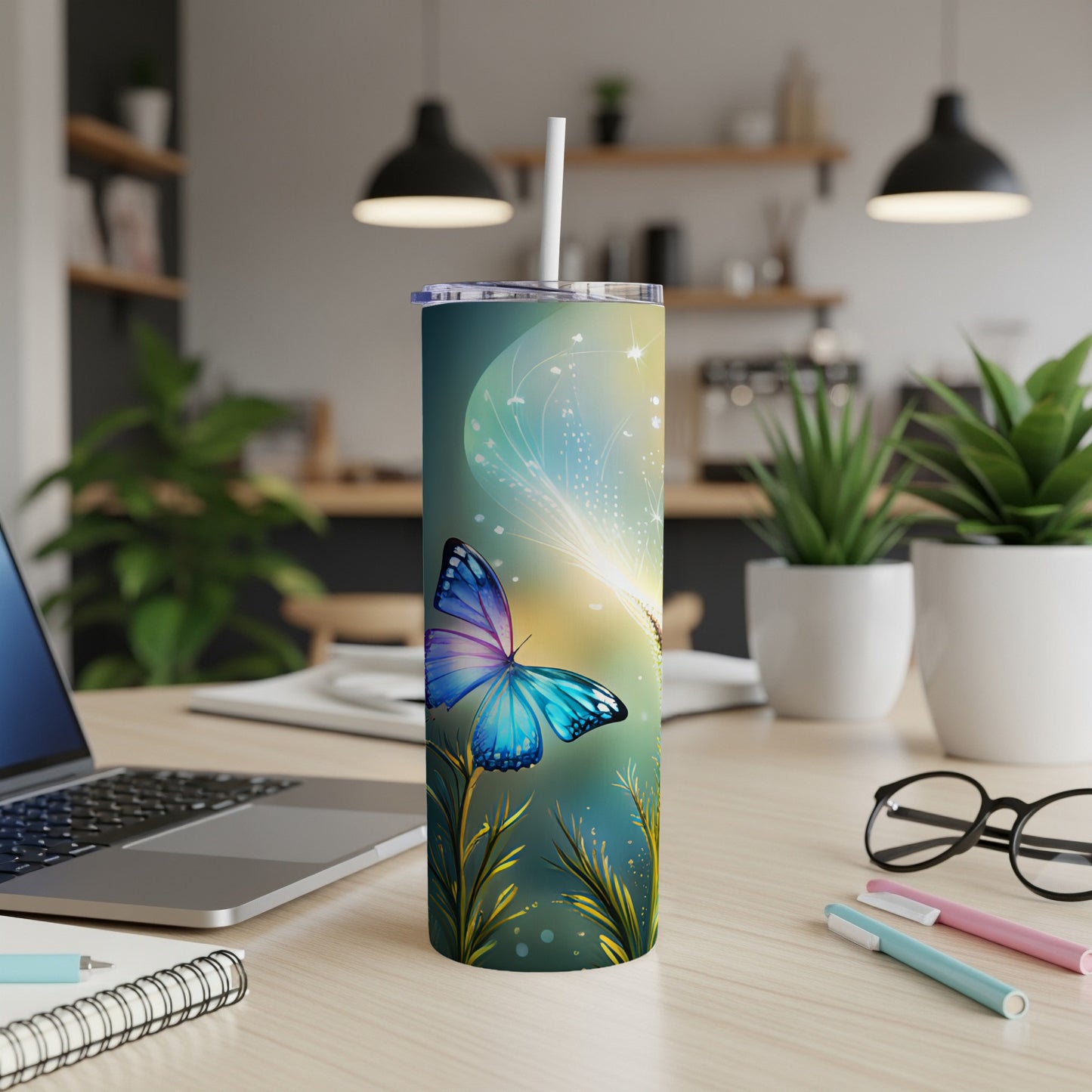 Blue butterfly on a blue tumbler with straw on a desk.
