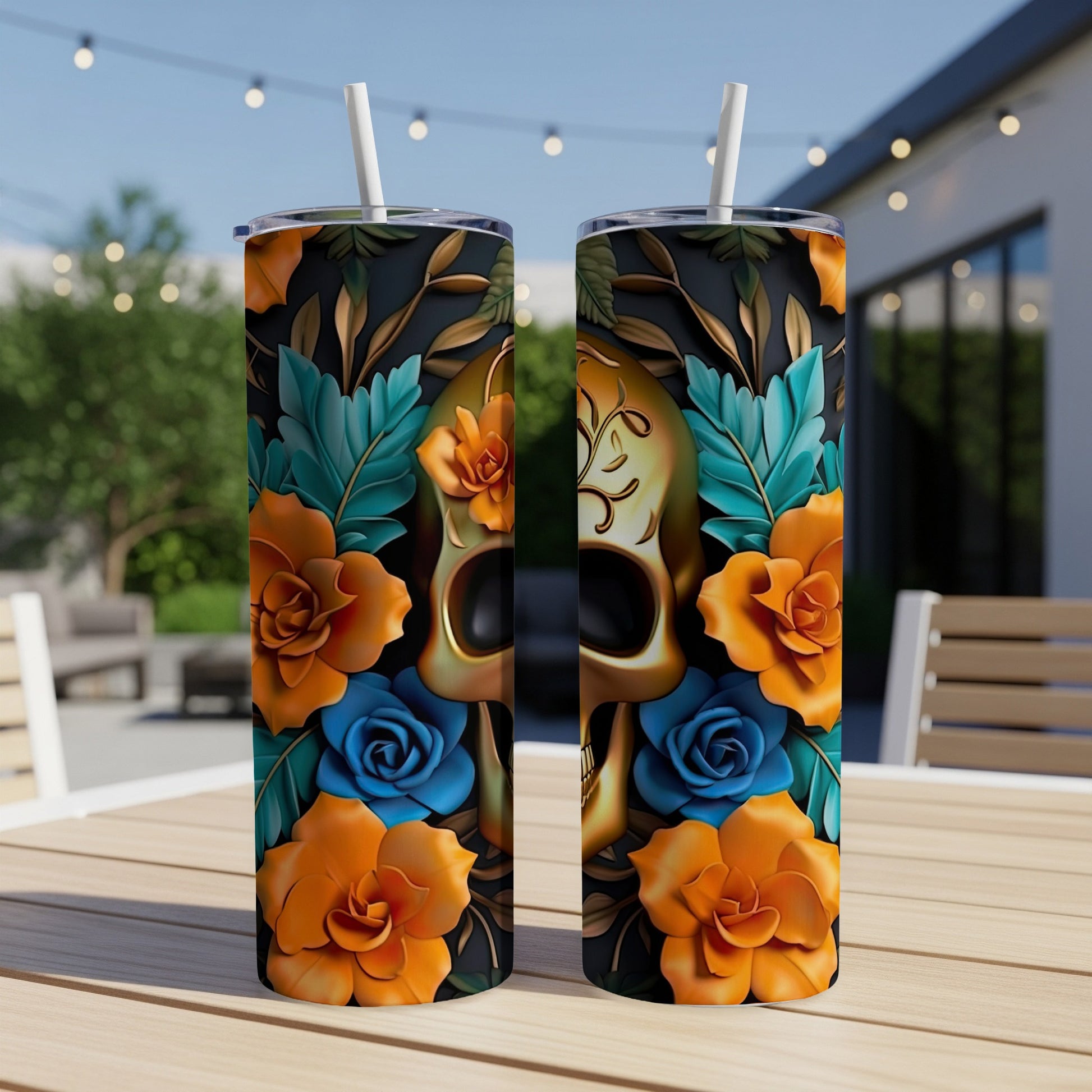 Two tumblers with a golden skull and floral design on a table.