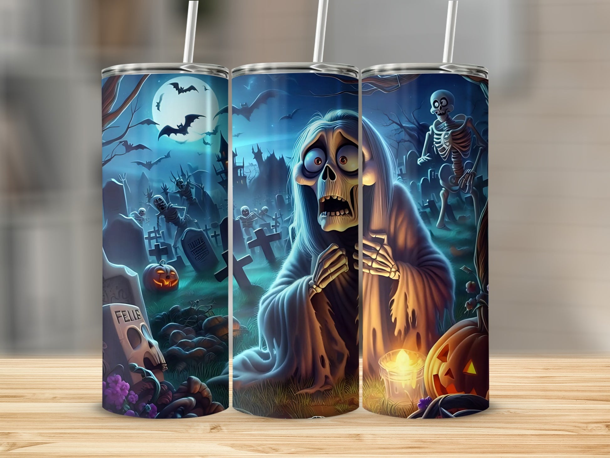 Halloween tumbler with skeletons, bats, a ghost, and pumpkins in a graveyard.