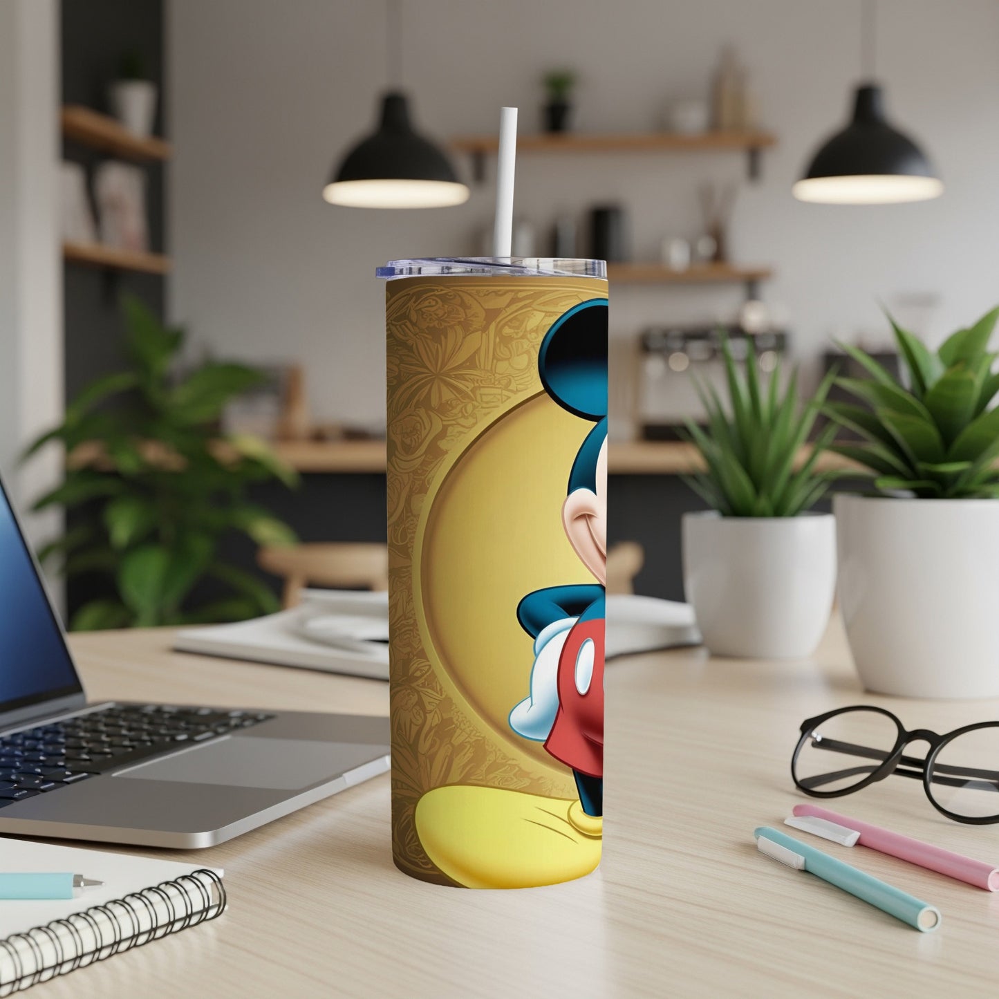 Mickey Mouse on a golden patterned tumbler with a straw.