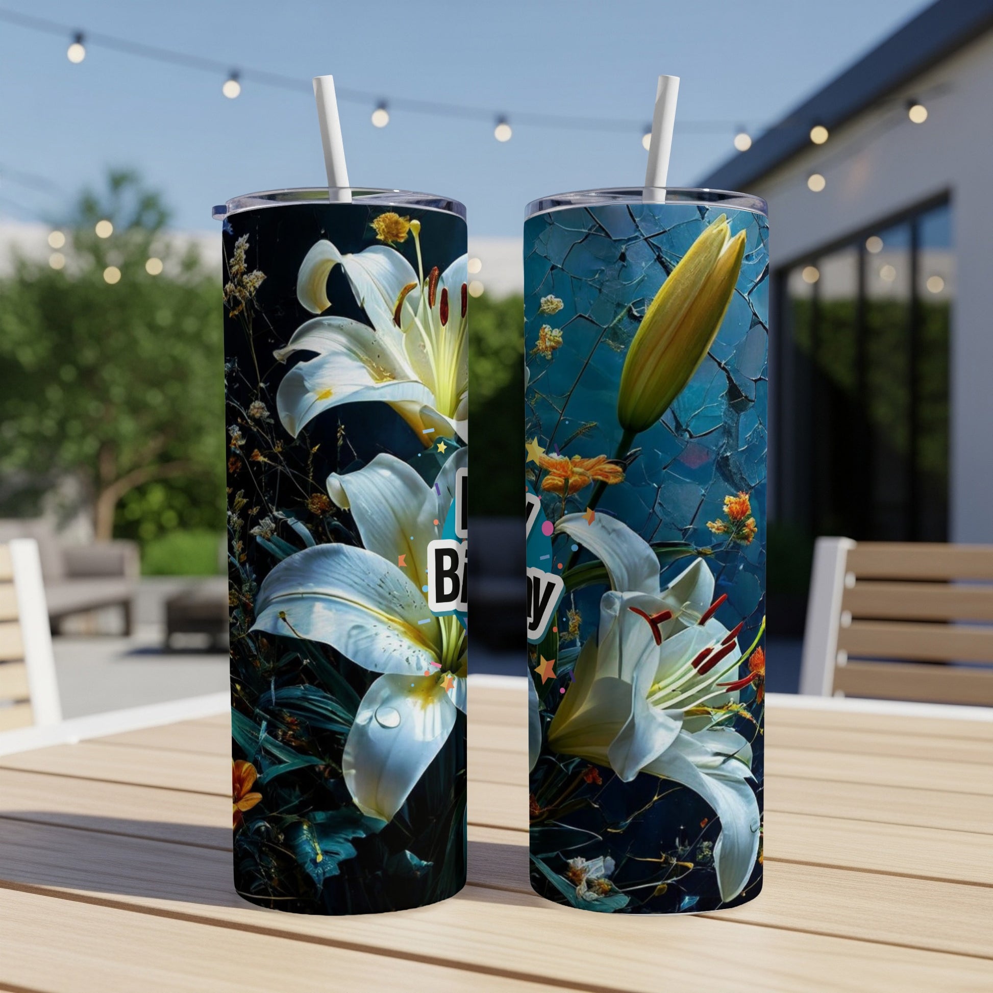 Two white lily tumblers with "Happy Birthday" text on a table.