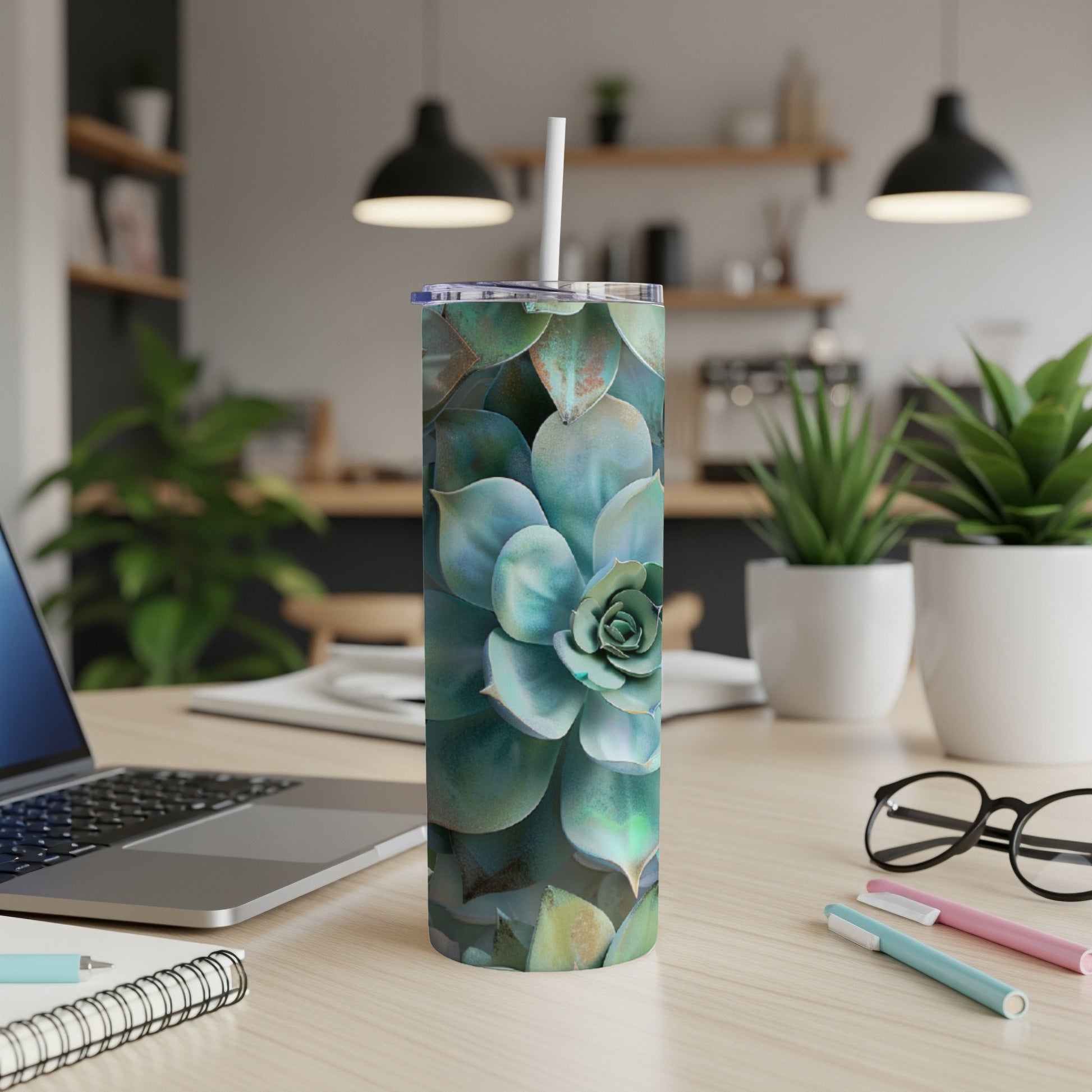 Succulent plant pattern on a white insulated tumbler with a straw.