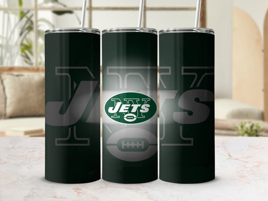 Three New York Jets tumblers with straws on a marble surface.