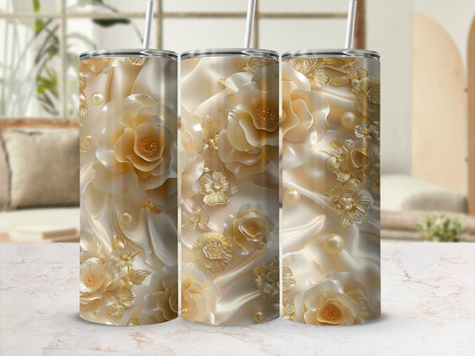 Triptych of tumblers with ornate gold floral and pearl designs on satin.