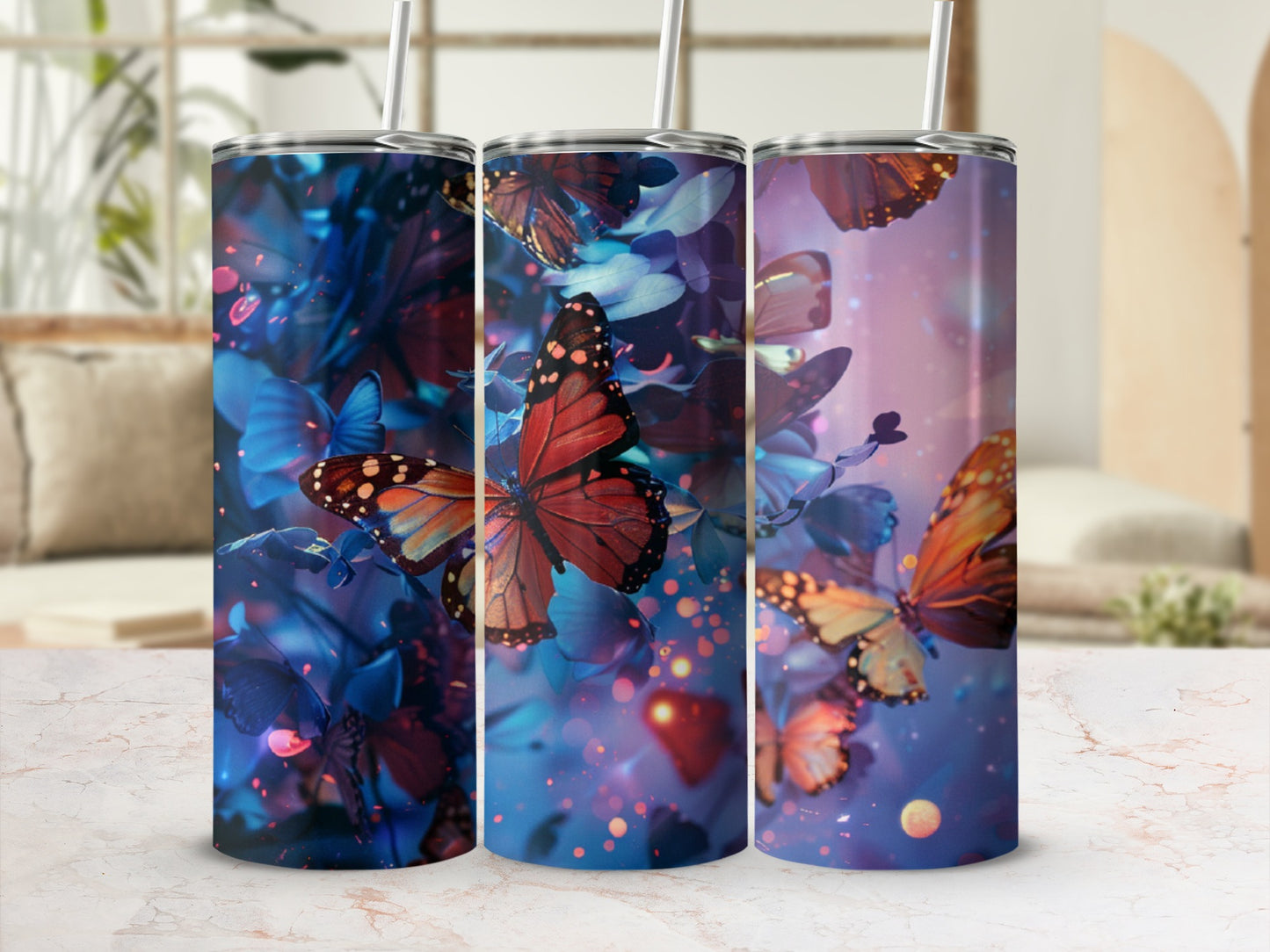 Three tall tumblers with vibrant butterfly and floral designs.