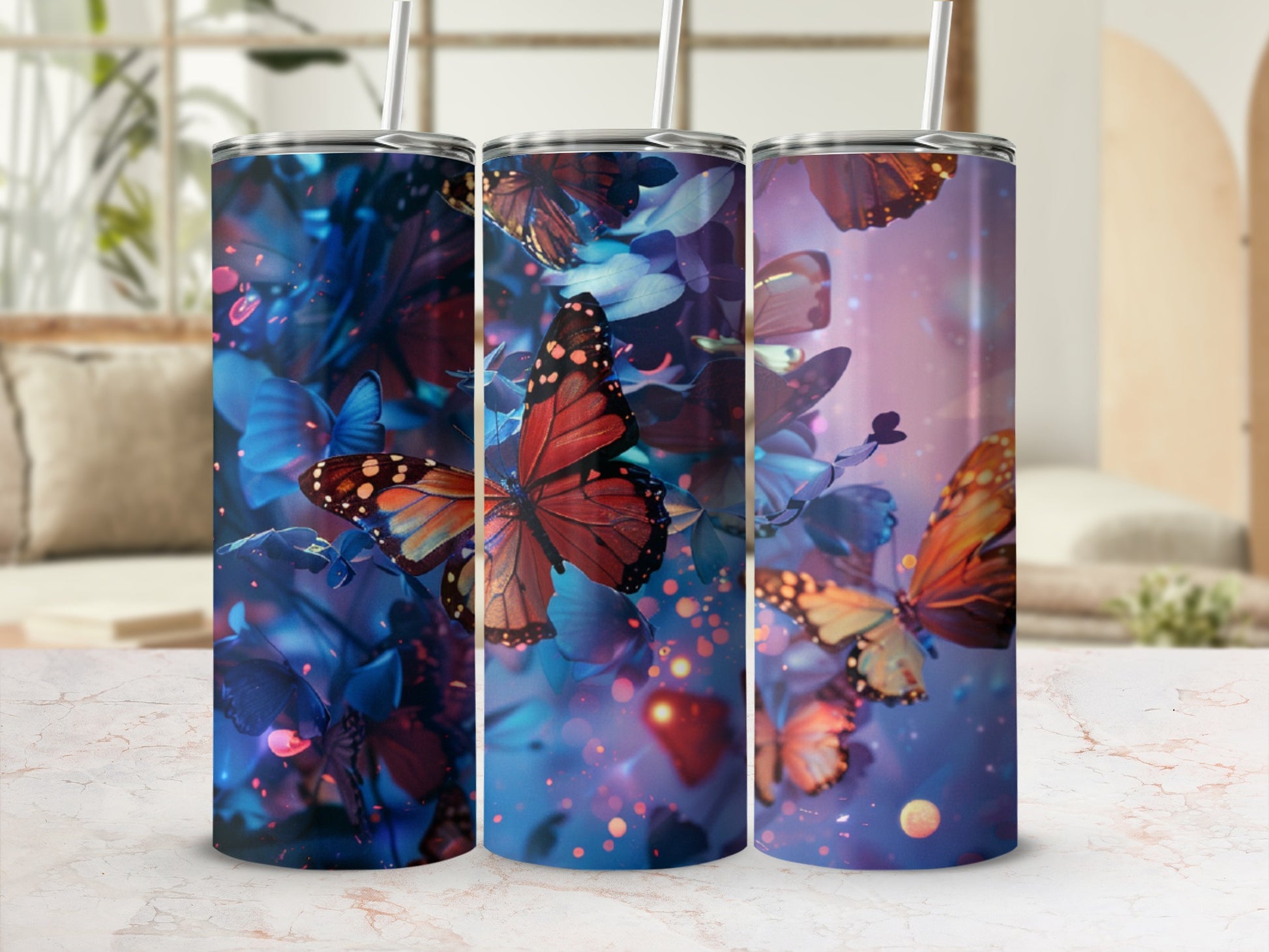 Three tall tumblers with vibrant butterfly and floral designs.