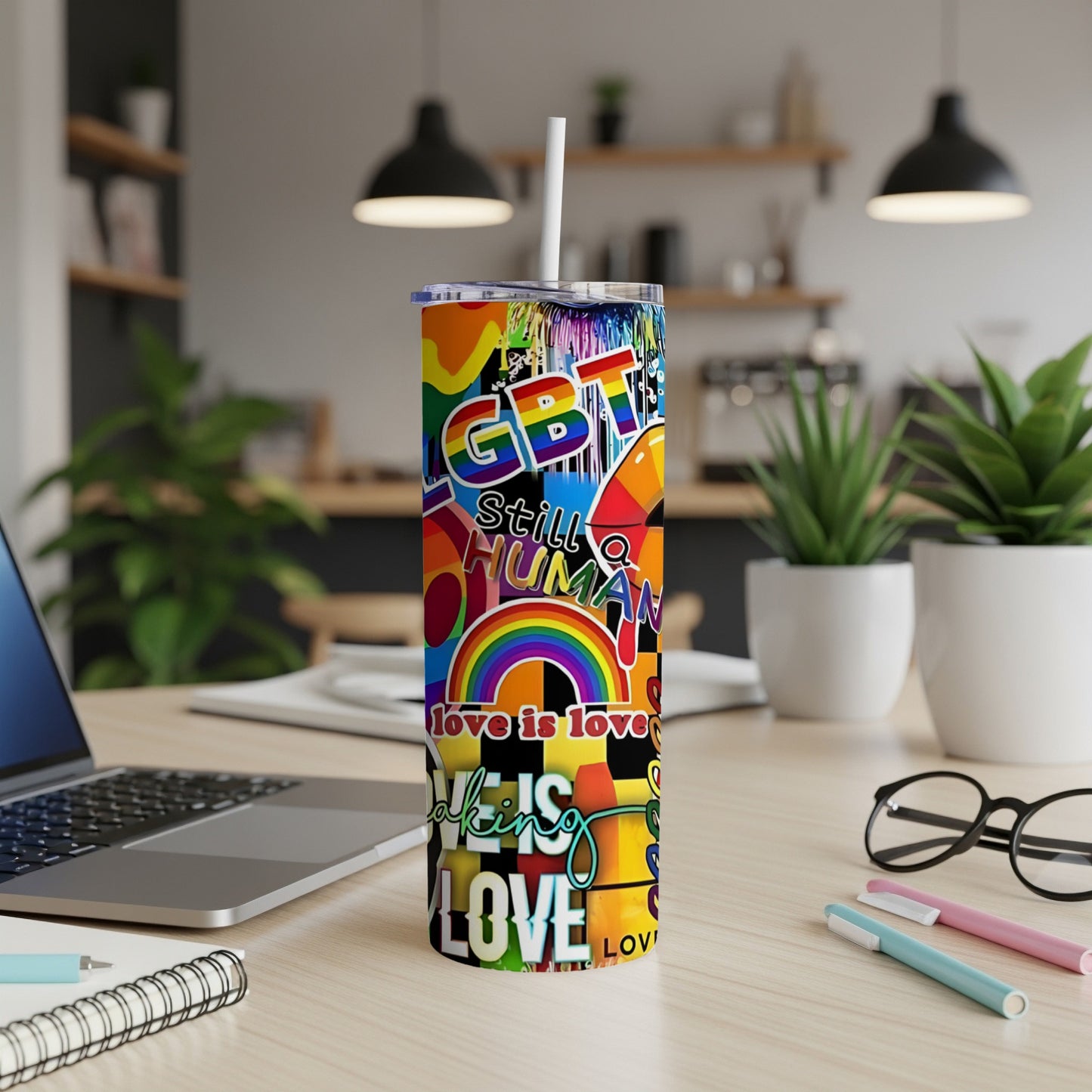 Rainbow LGBT pride tumbler with "Still Human," "Love is Love" text.