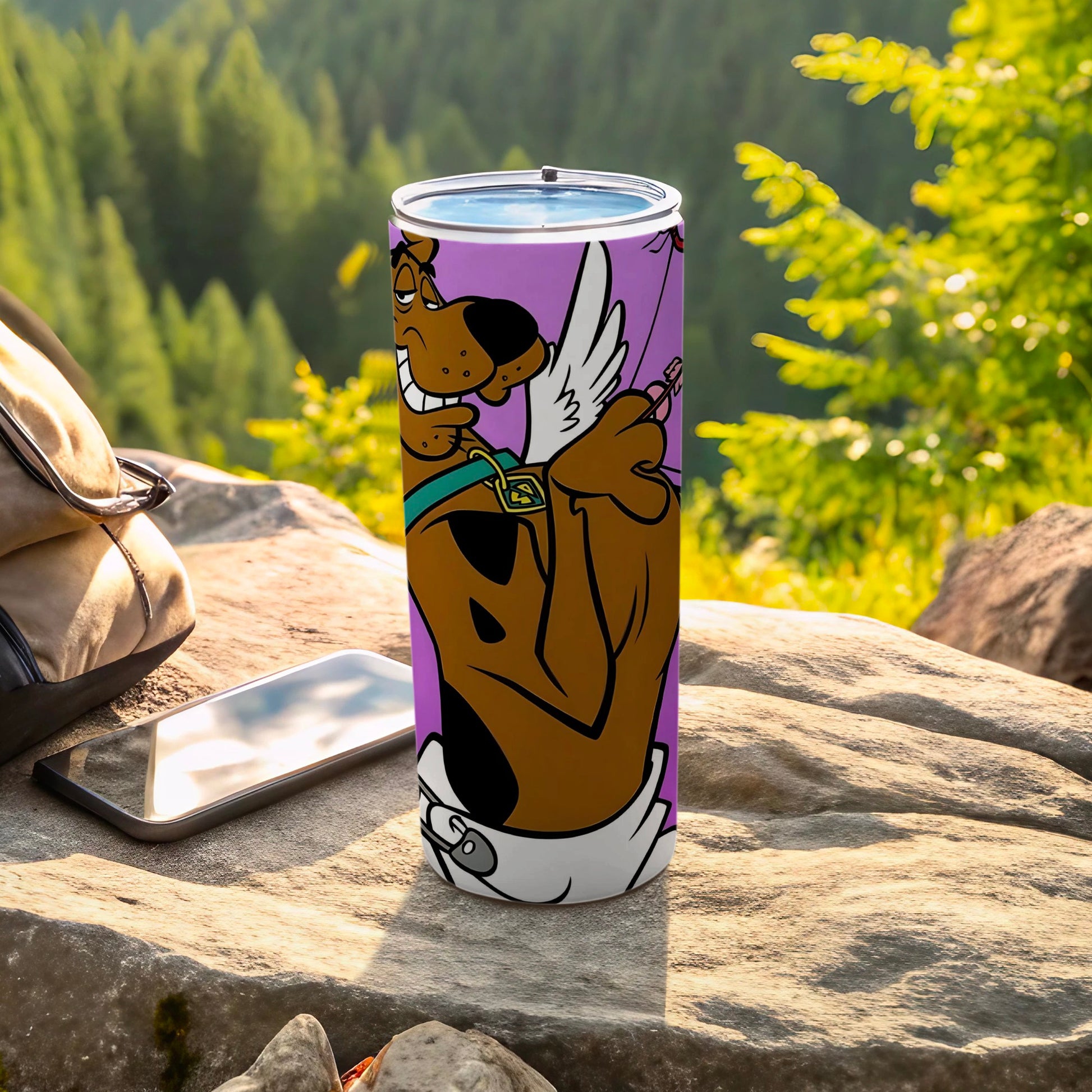 Scooby-Doo on a purple tumbler with angel wings, outdoors.