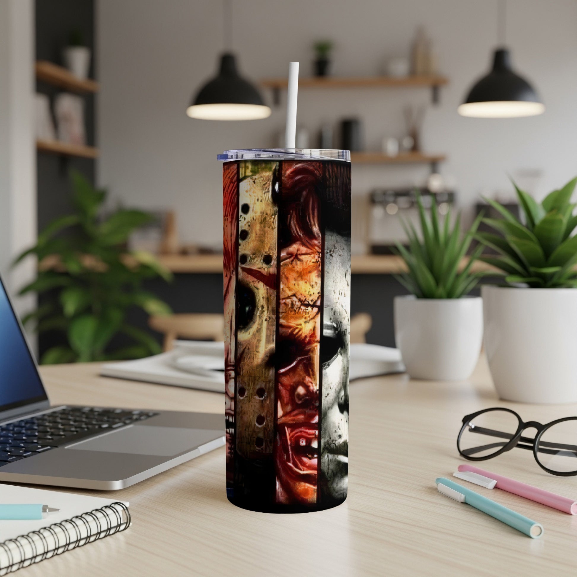 Tumbler with montage of horror movie characters' faces and straw.