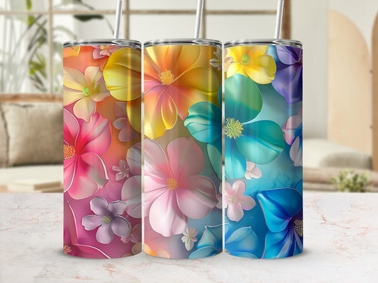 Three tumblers with colorful floral patterns in ombre shades of pink, yellow, and blue.