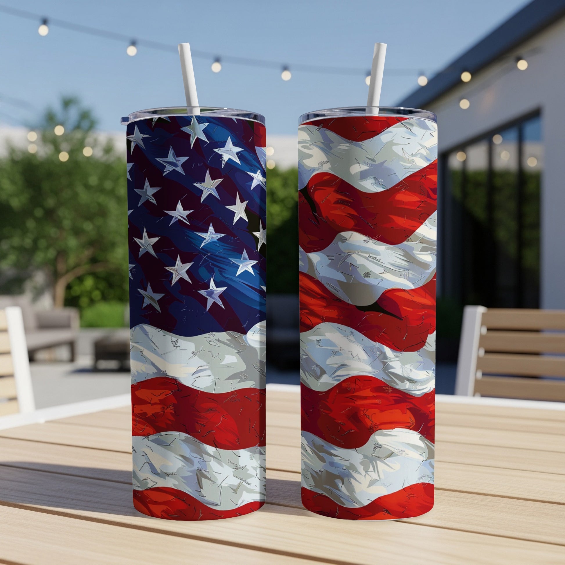 Two tumblers with American flag design on outdoor table.