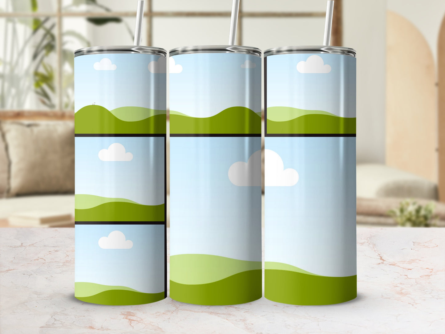 Three tumblers with a landscape design of green hills and blue sky with clouds.