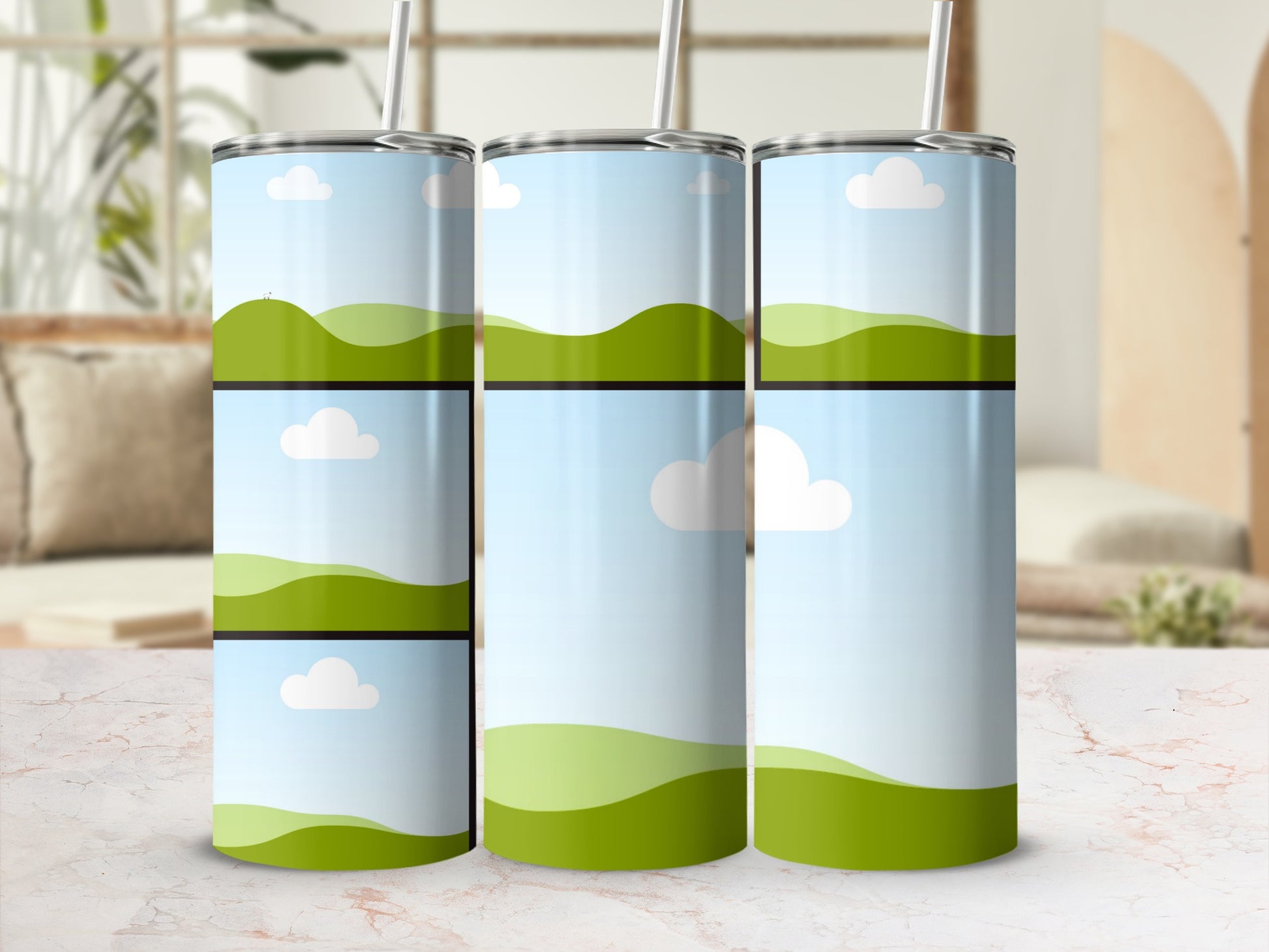 Three tumblers with a landscape design of green hills and blue sky with clouds.
