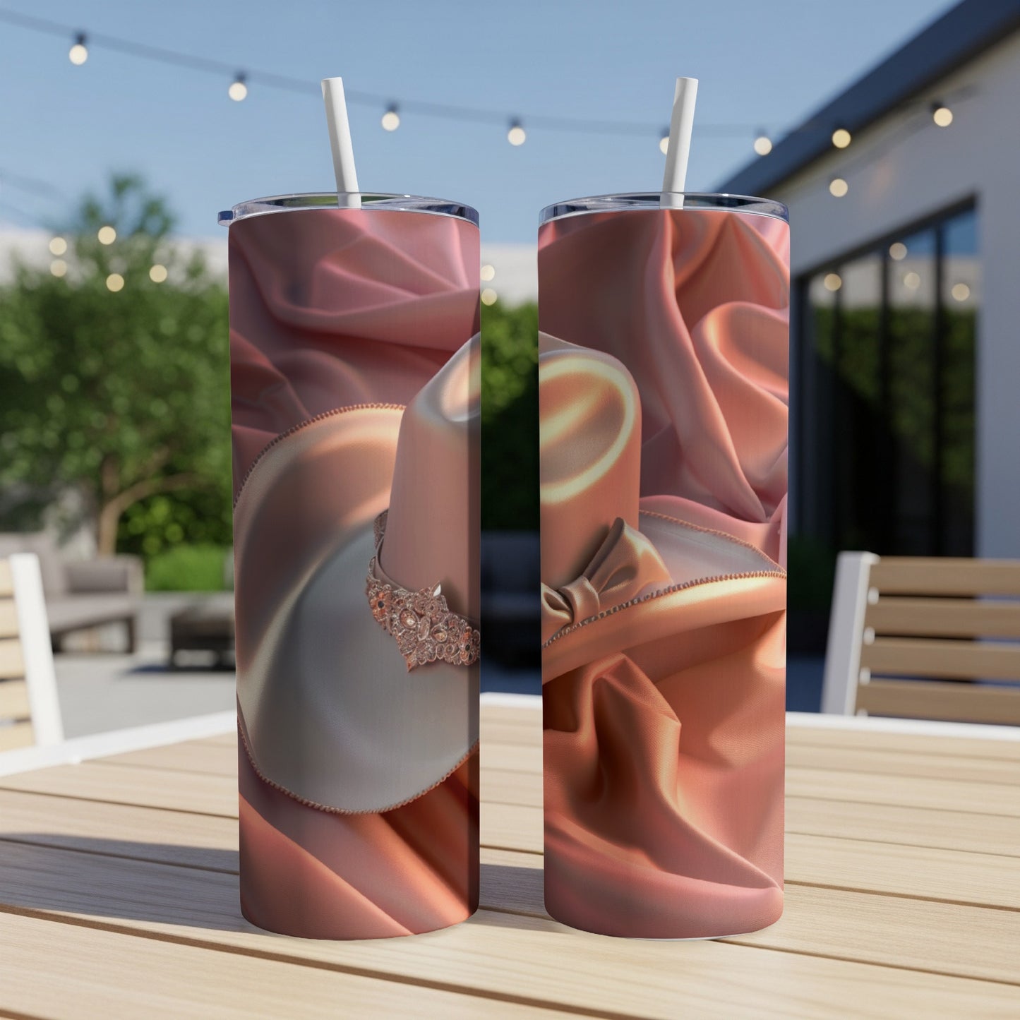 Two tumblers with a pink satin fabric and hat design.