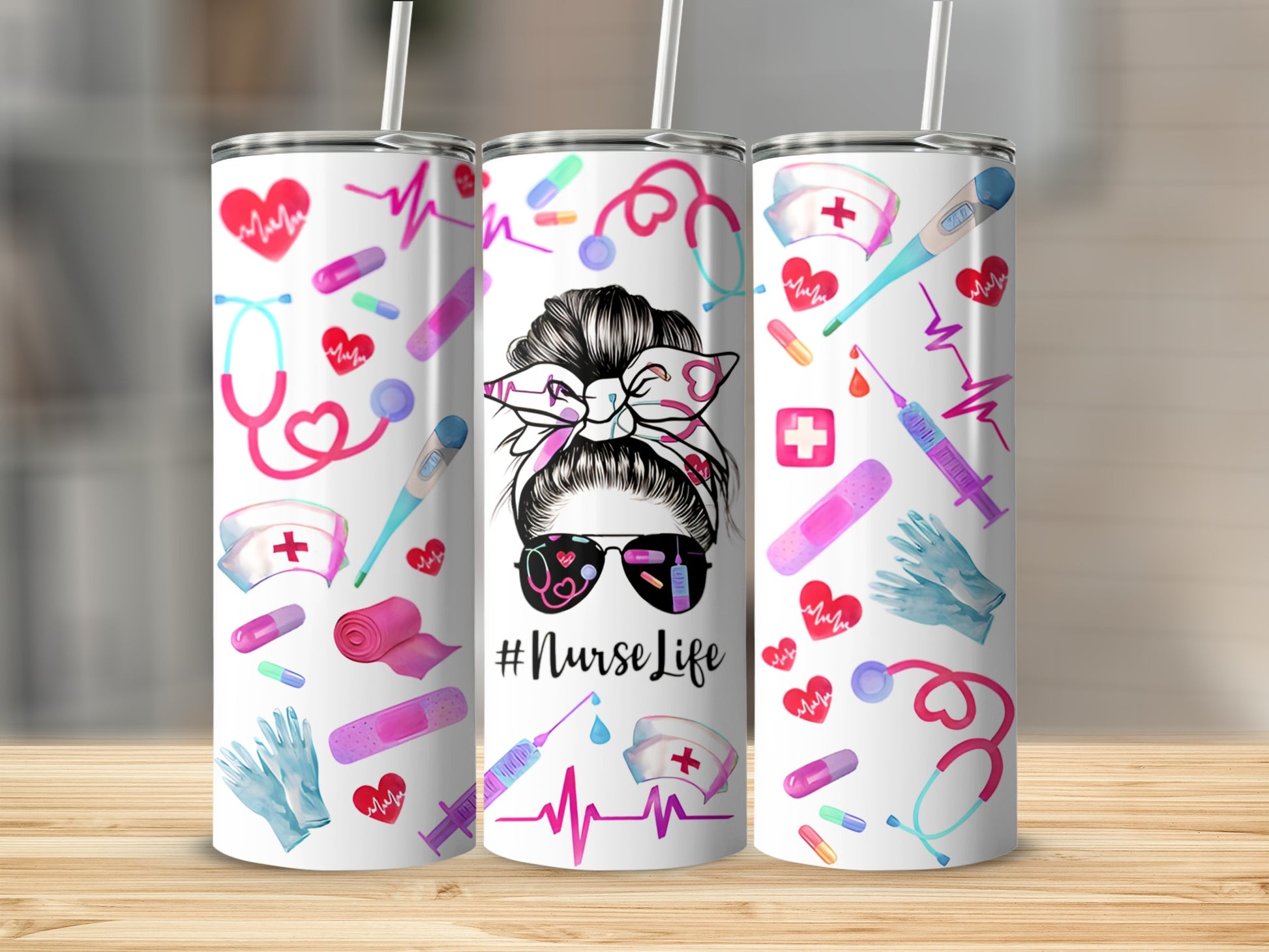 Three tumblers with nurse-themed graphics on a wooden surface.