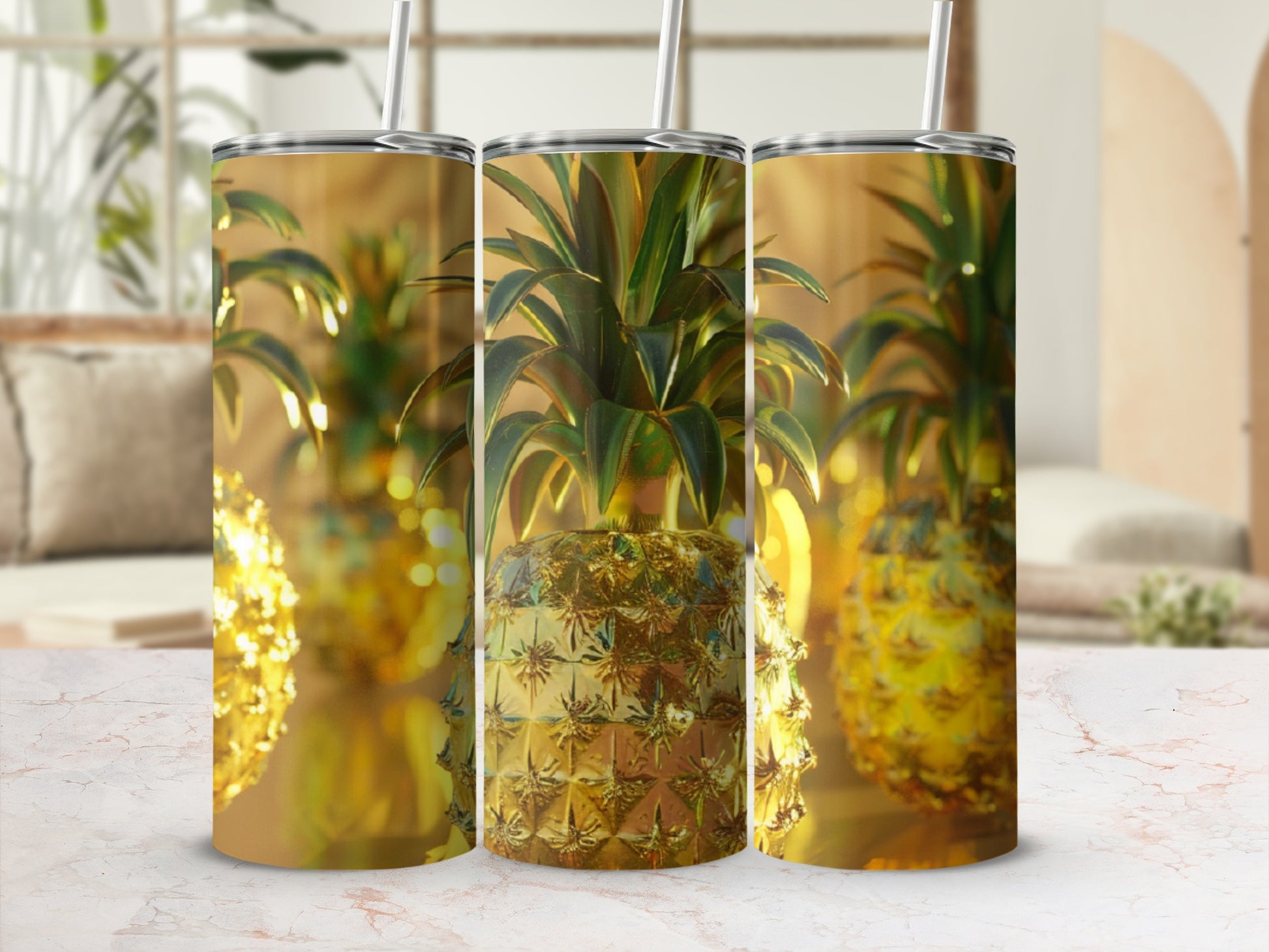 Three golden pineapple tumblers with textured surfaces and straws.