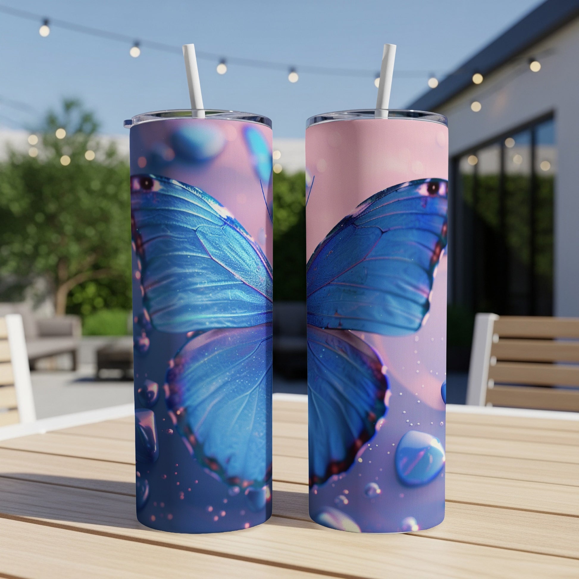 Two tall tumblers with a detailed blue butterfly design and water droplets.