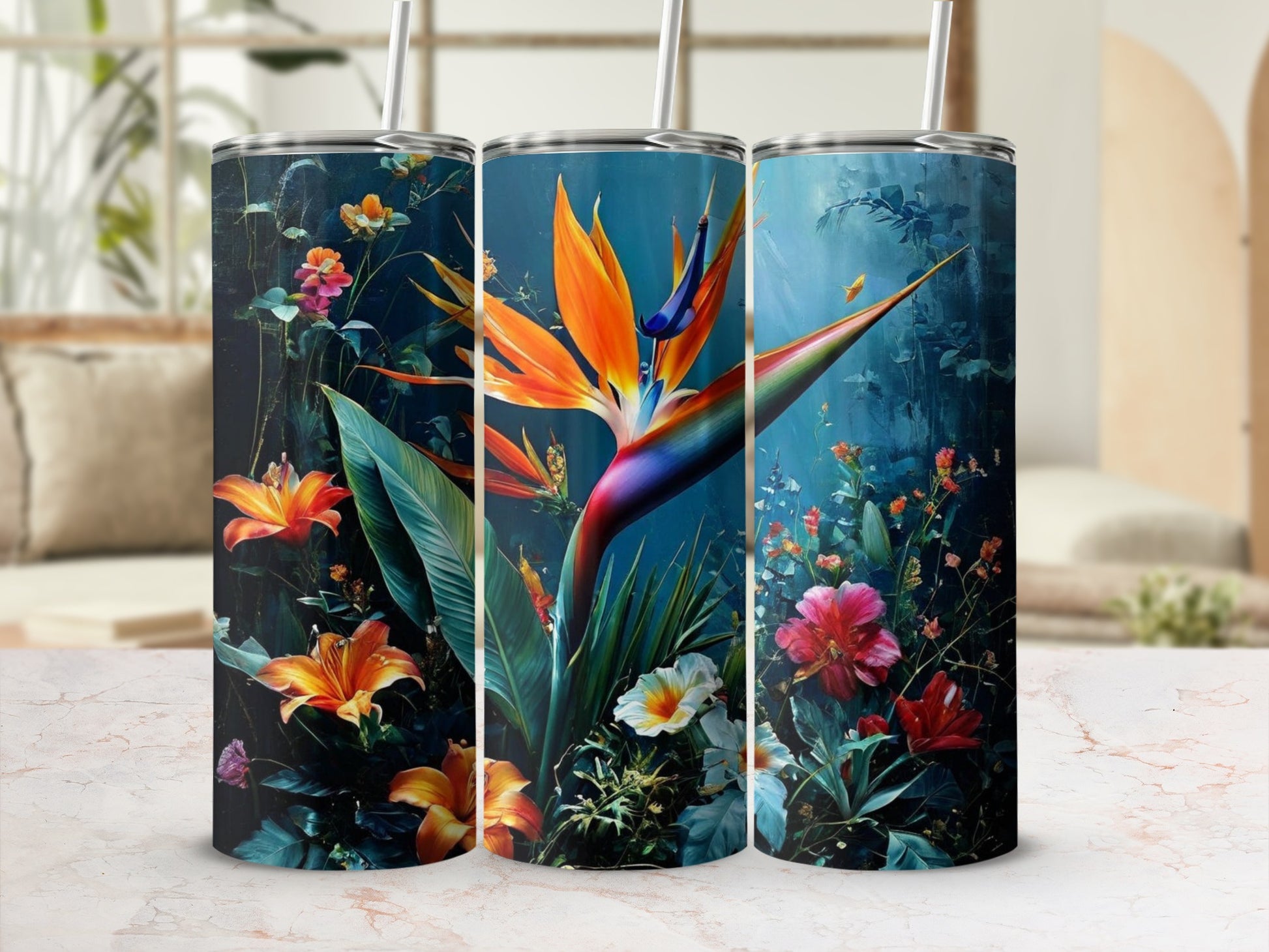 Three tumblers with vibrant floral patterns featuring bird of paradise flowers.