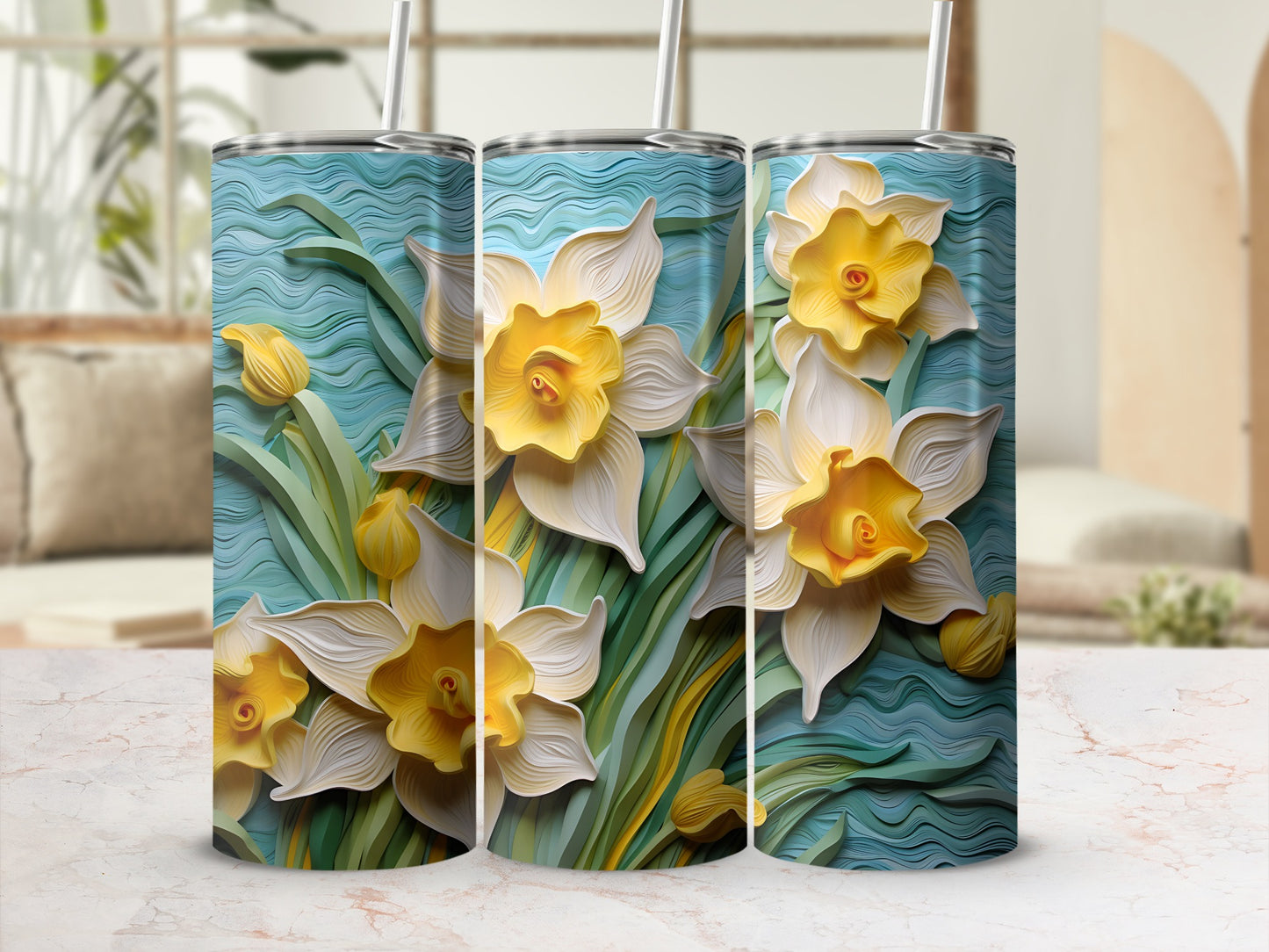 Three tumblers with a raised relief floral design of yellow and white daffodils.