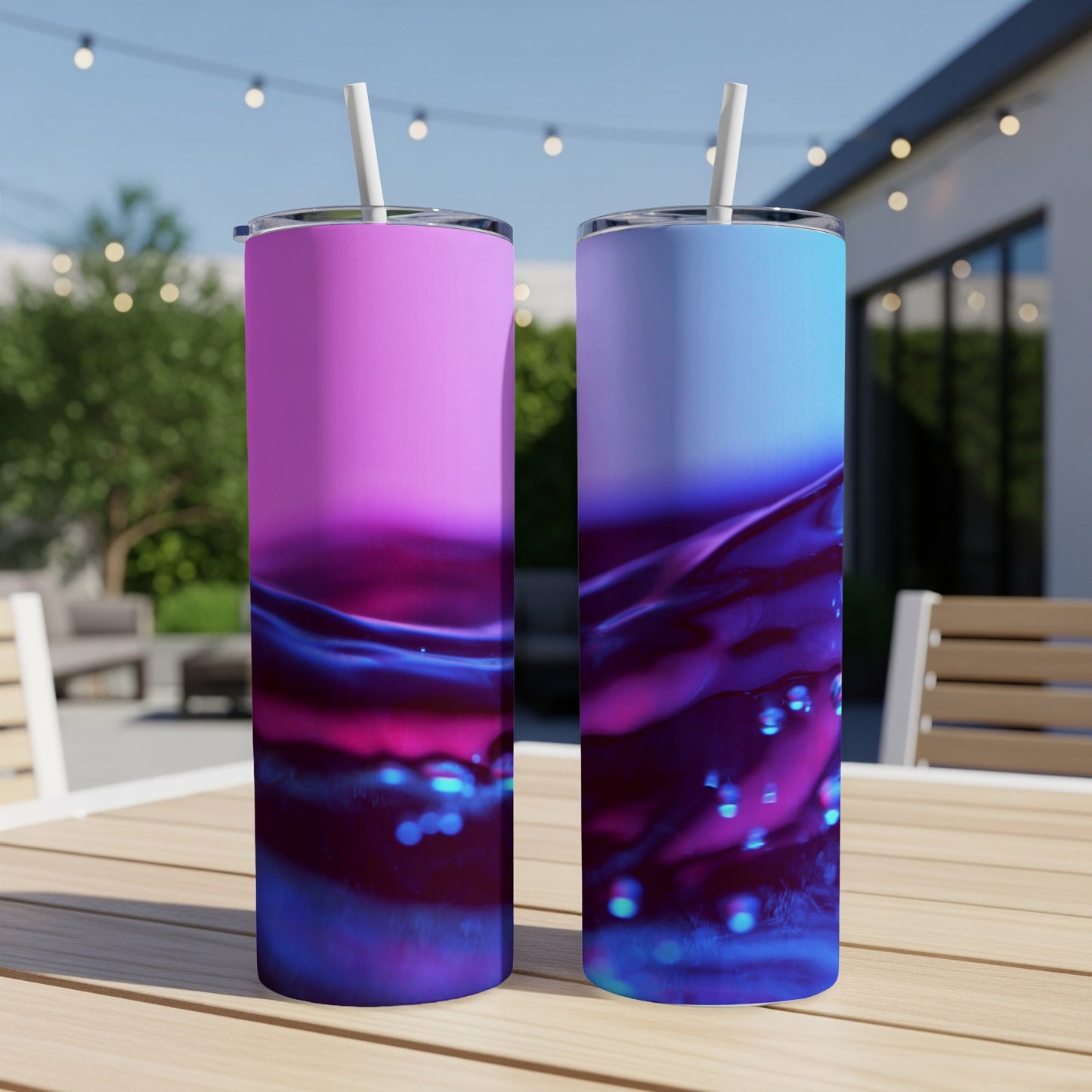 Two tall tumblers with purple and blue ombre liquid design, straws inserted.
