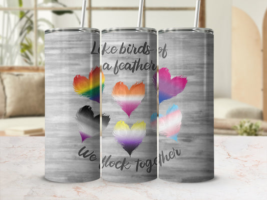 Tumbler with rainbow, non-binary, and trans pride heart feathers and text.