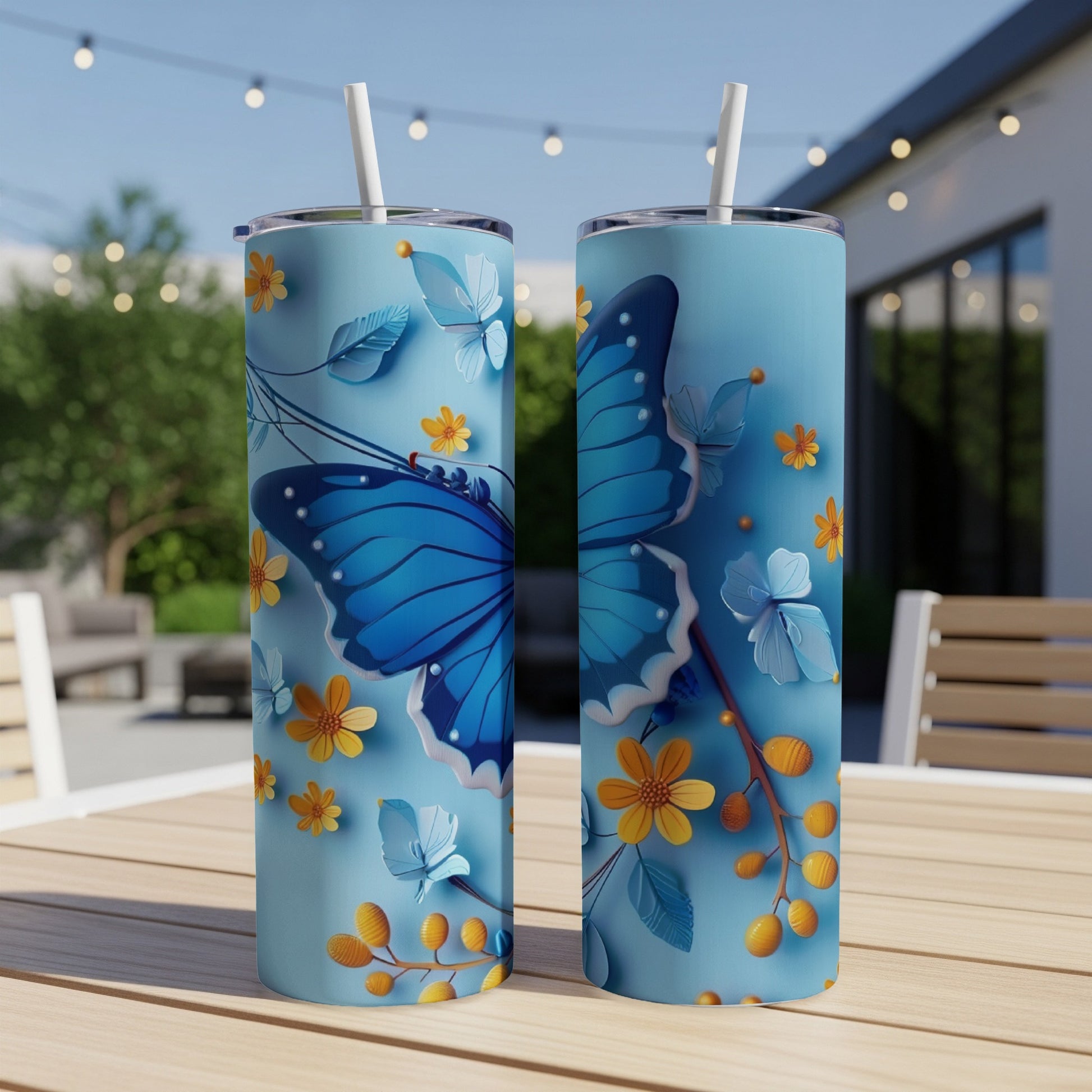 Two blue tumblers with a detailed blue butterfly and floral design.