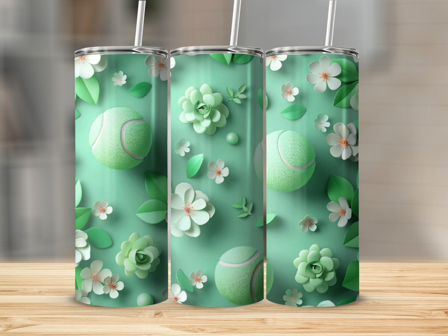 Three mint green tumblers with tennis balls and floral patterns.