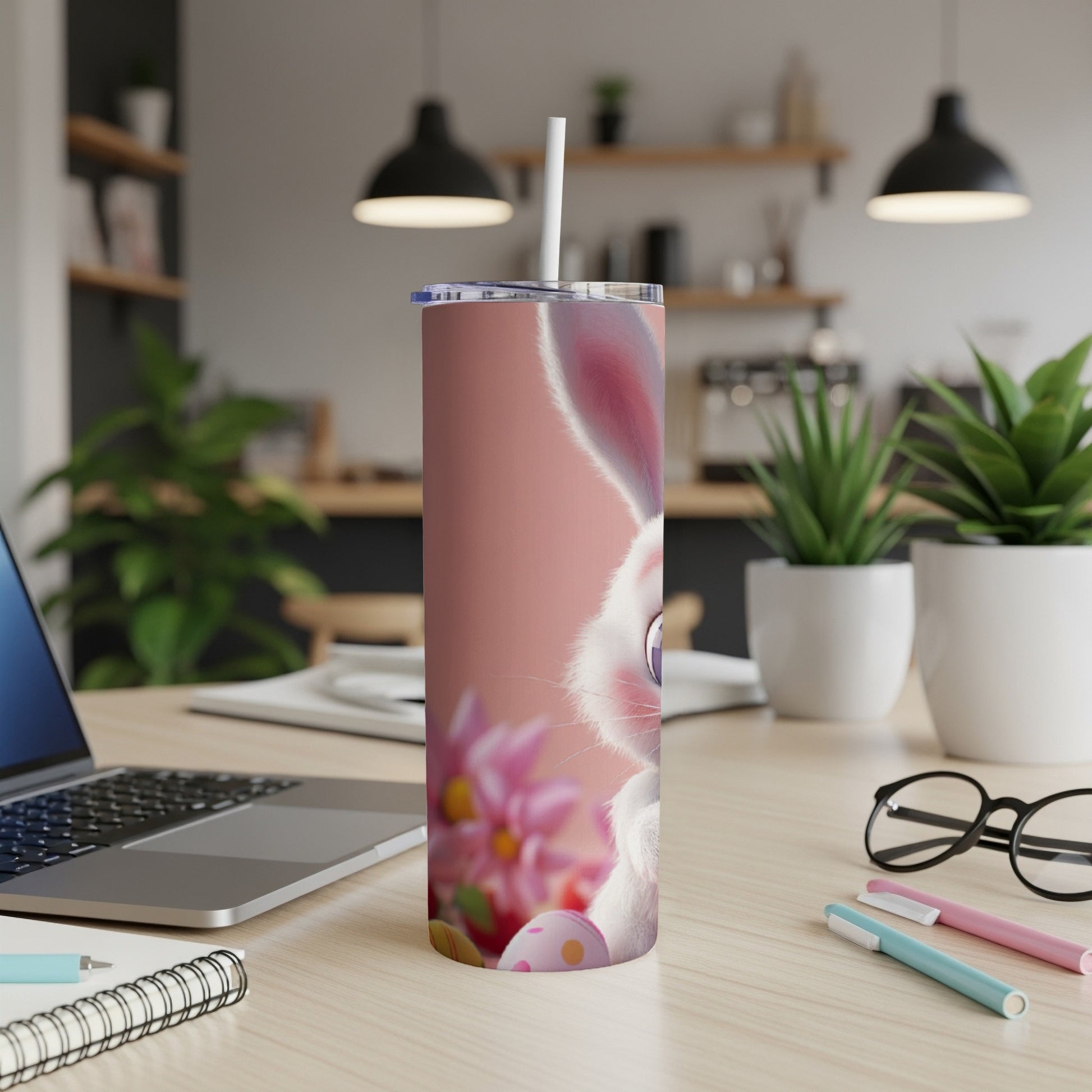 Pink tumbler with a cartoon Easter bunny, flowers, and Easter eggs.