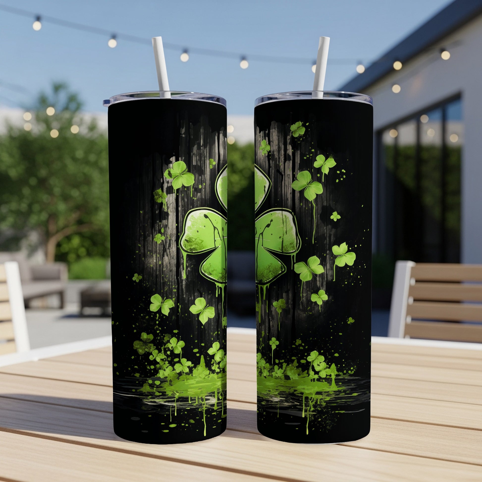 Green shamrock design on a black tumbler with dripping paint effect.