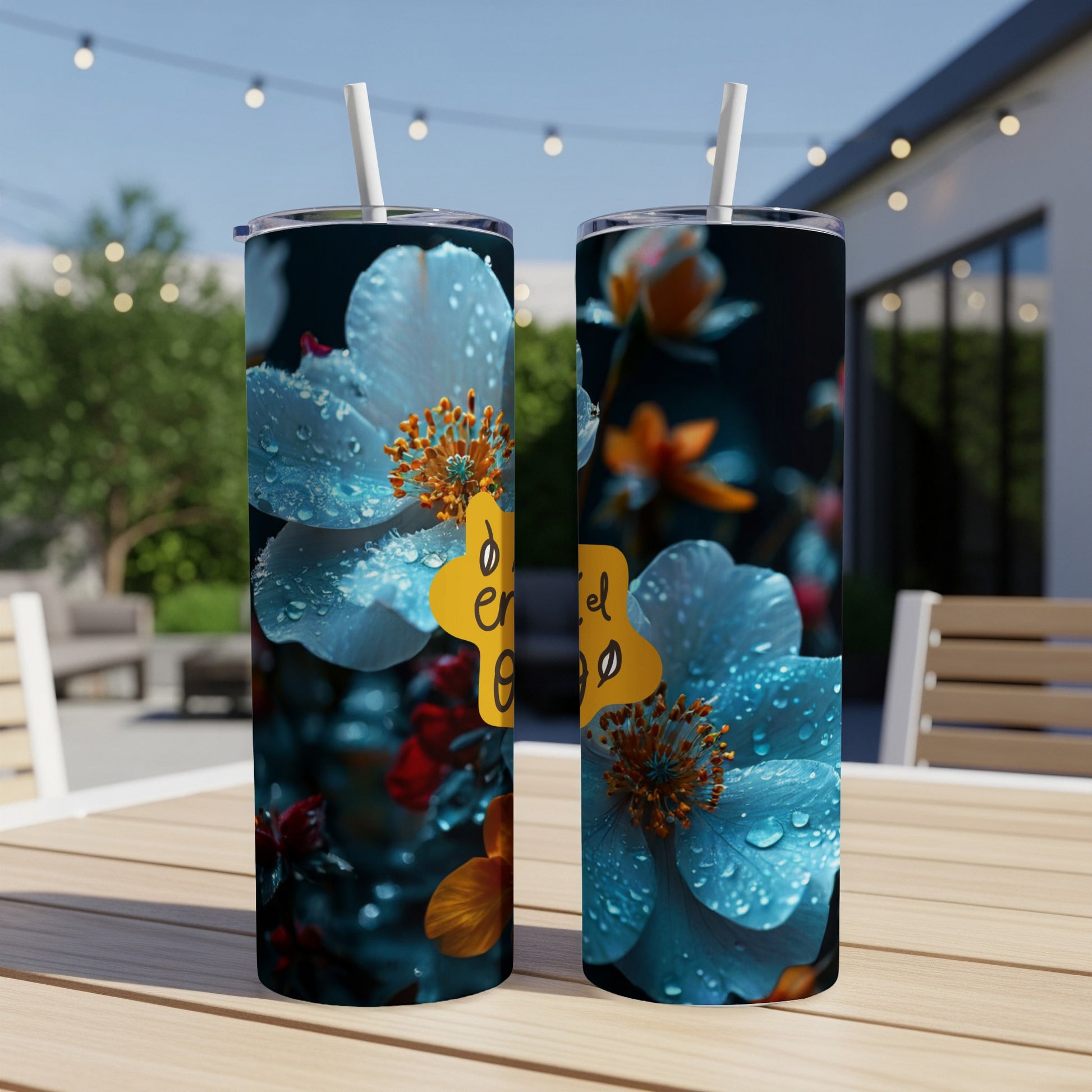 Two tumblers with blue flowers and "en el ego" text on a table.