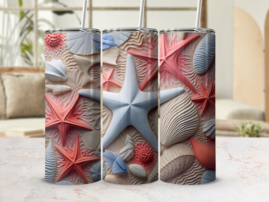Three tumblers with starfish and seashell designs on a marble surface.
